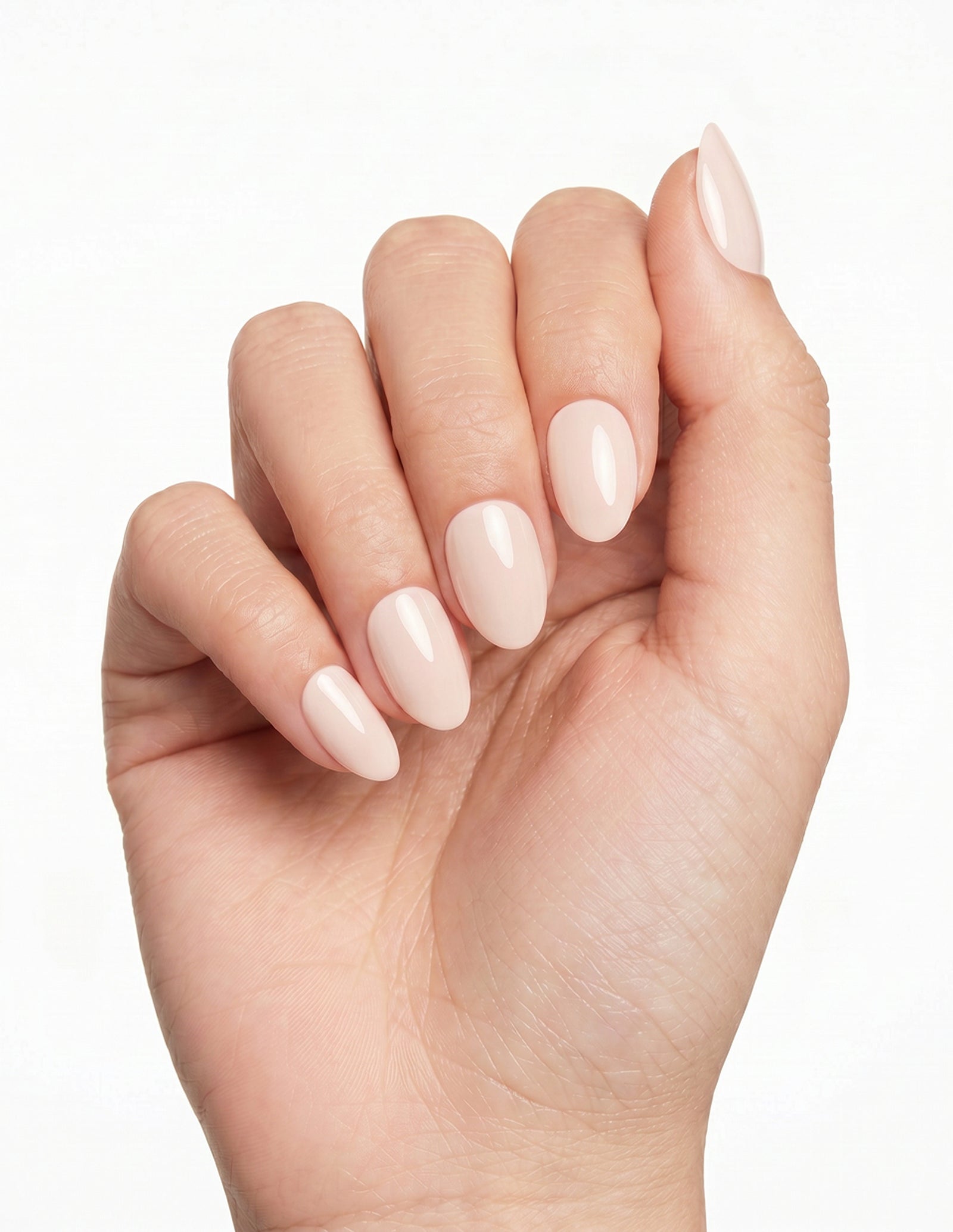 Cream Crème press-on nails — Almond (extra-short), light-skin hand, fingers curled