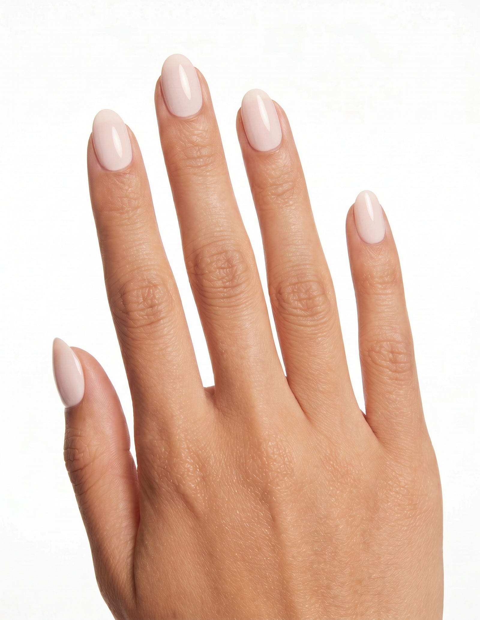 Cream Crème press-on nails — Almond (extra-short), tan hand, back of hand