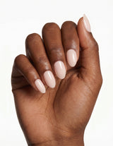Cream Crème press-on nails — Almond (extra-short), deep-skin hand, fingers curled