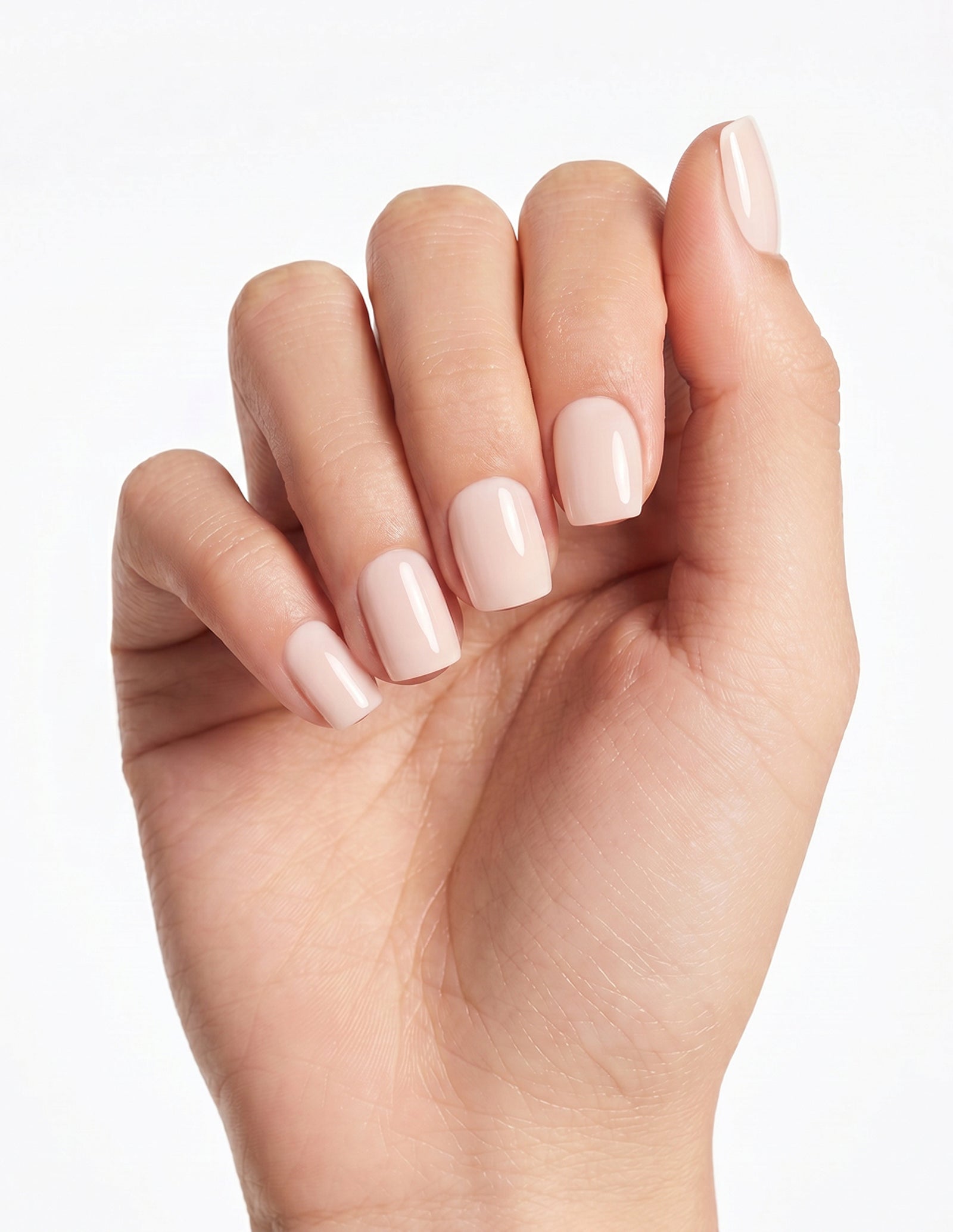 Cream Crème press-on nails — Coffin (short), light-skin hand, fingers curled