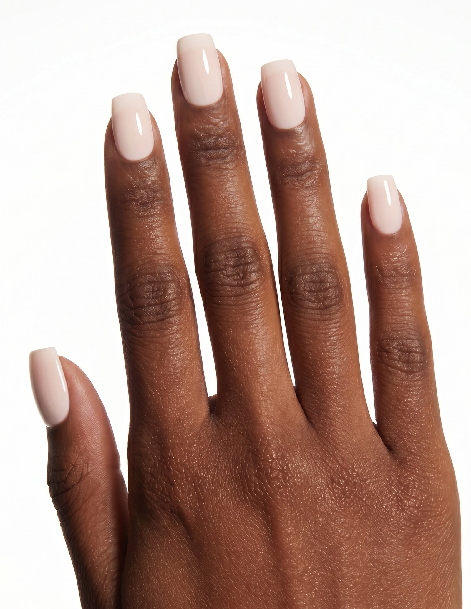 Cream Crème press-on nails — Coffin (short), deep-skin hand, back of hand
