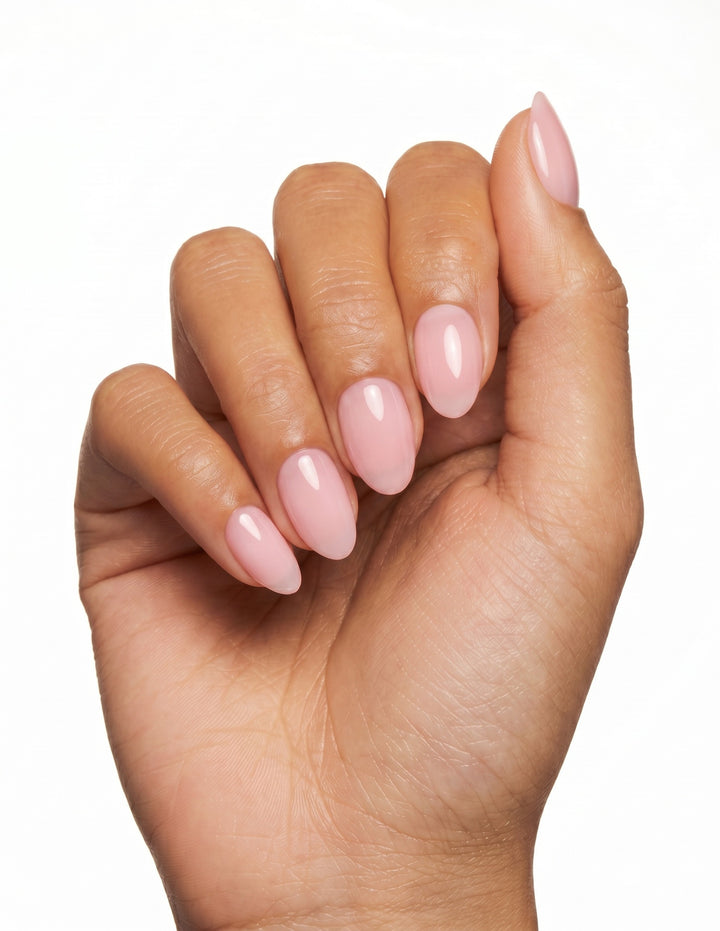 Ballet Slipper press-on nails — Almond (extra-short), tan hand, fingers curled