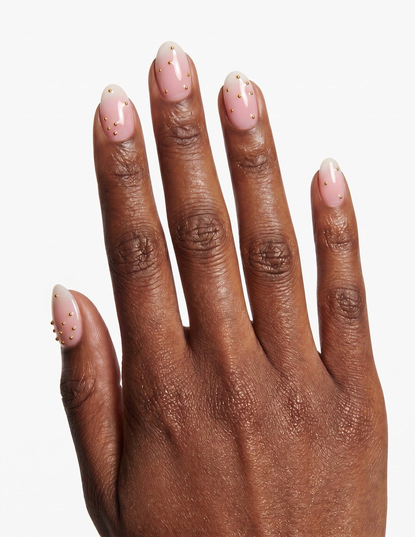 Champagne Dots press-on nails — Almond (extra-short), deep-skin hand, back of hand