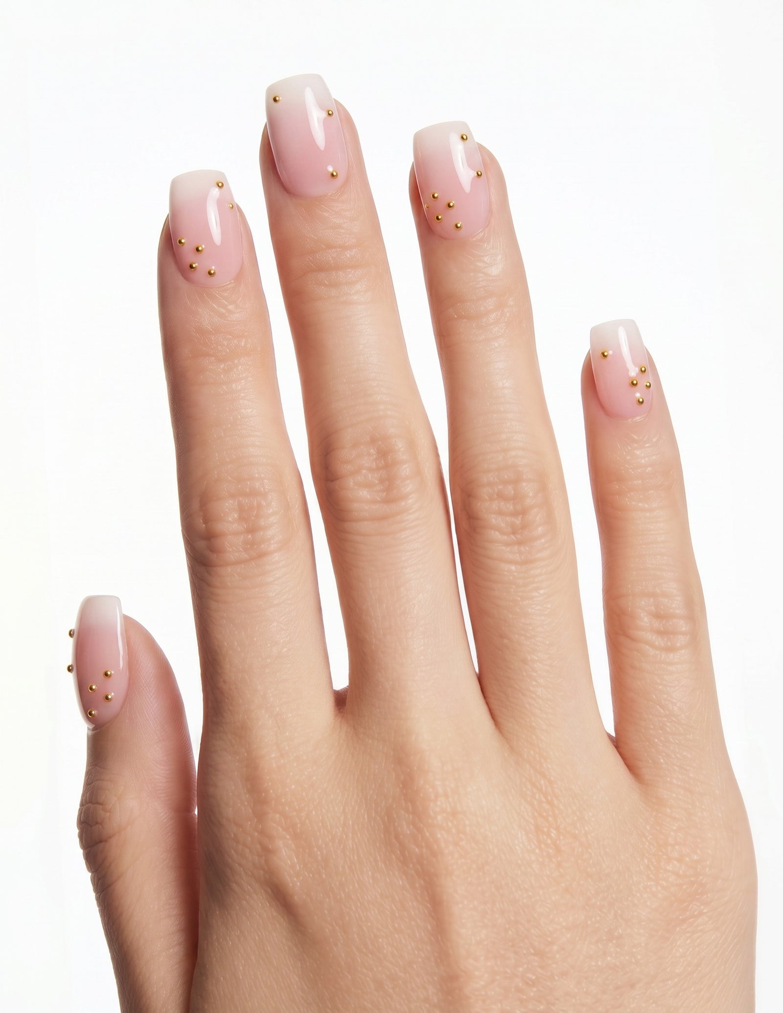 Champagne Dots press-on nails — Coffin (short), light-skin hand, back of hand