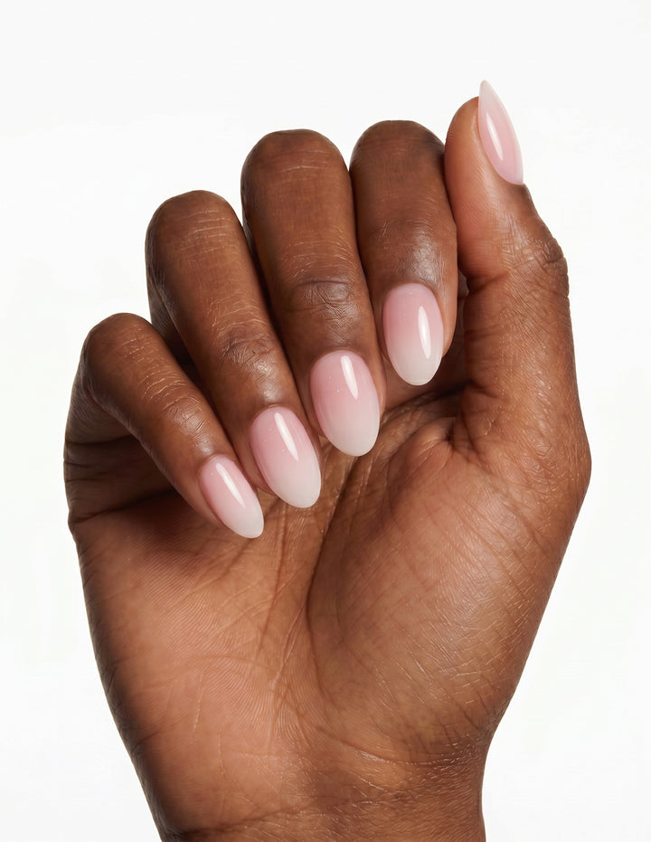 Milk Bath press-on nails — Almond (extra-short), deep-skin hand, fingers curled