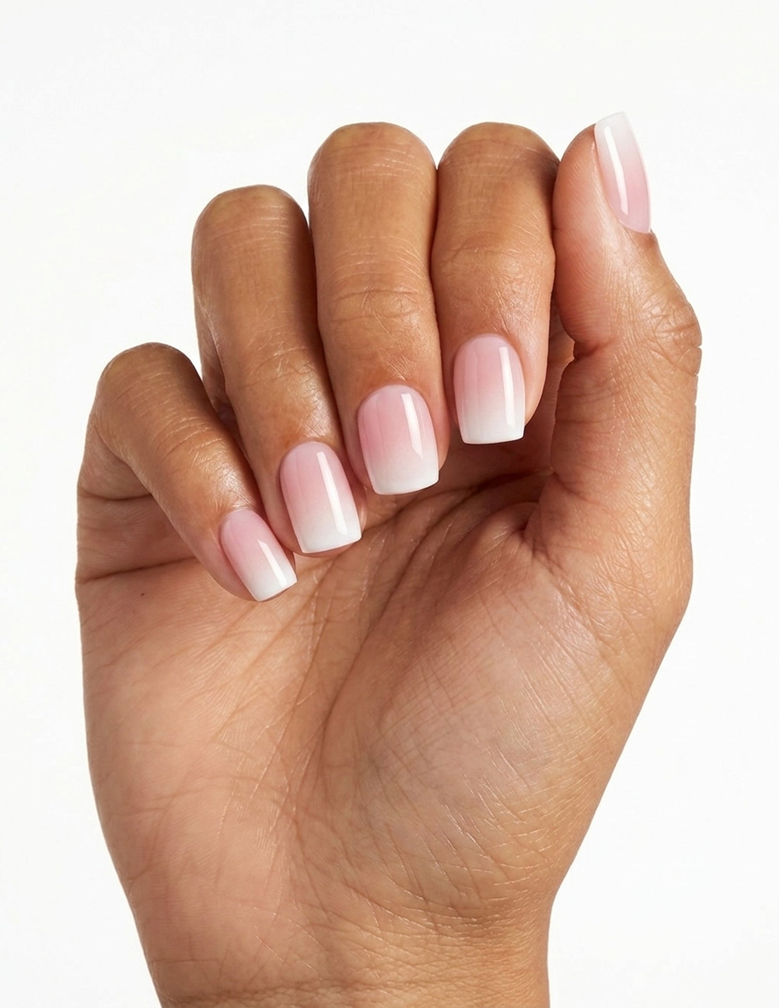 Milk Bath press-on nails — Coffin (short), tan hand, fingers curled
