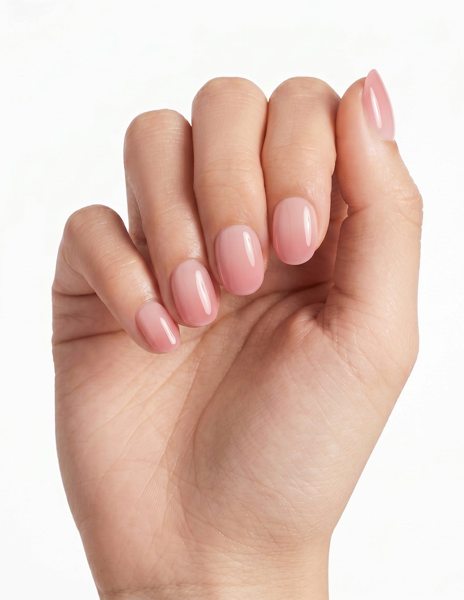 First Blush press-on nails — Oval (extra-short), light-skin hand, fingers curled