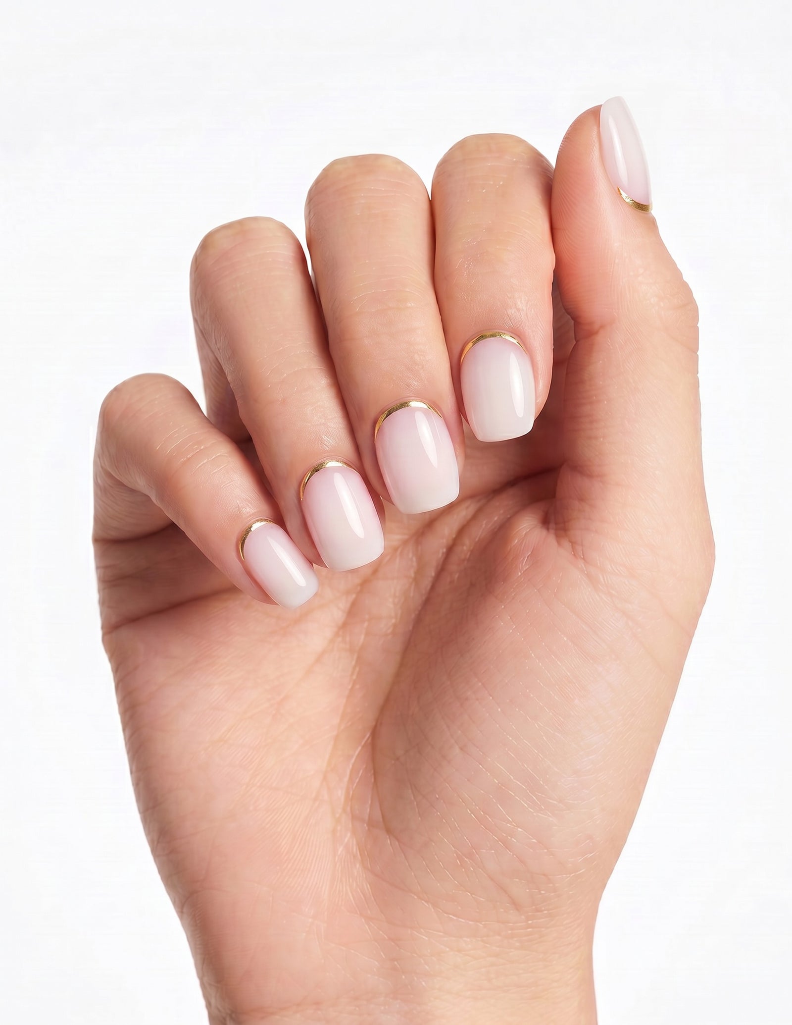 Gold Leaf press-on nails — Coffin (short), tan hand, fingers curled