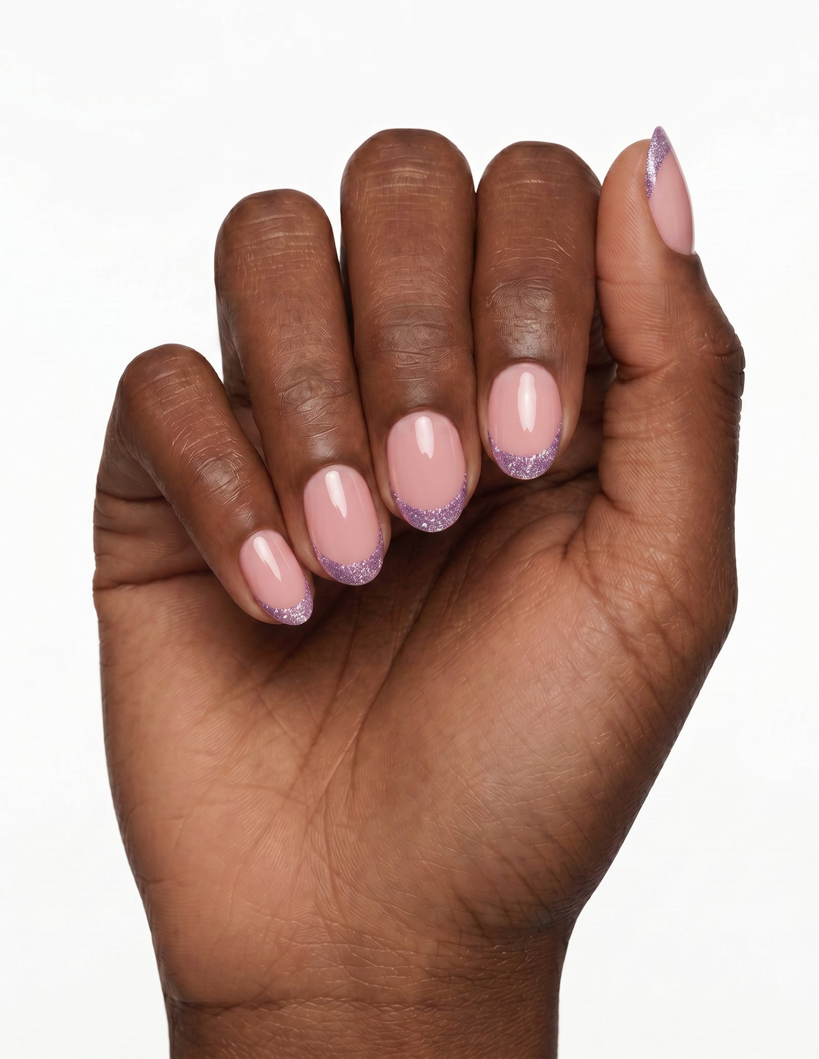 Opal Tips press-on nails — Oval (extra-short), deep-skin hand, fingers curled