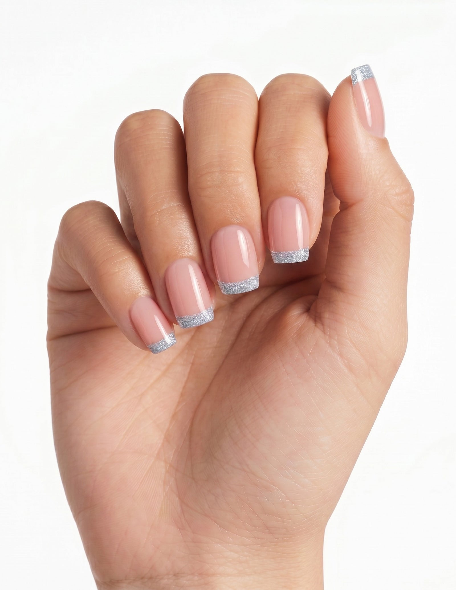 Something Blue press-on nails — Coffin (short), tan hand, fingers curled