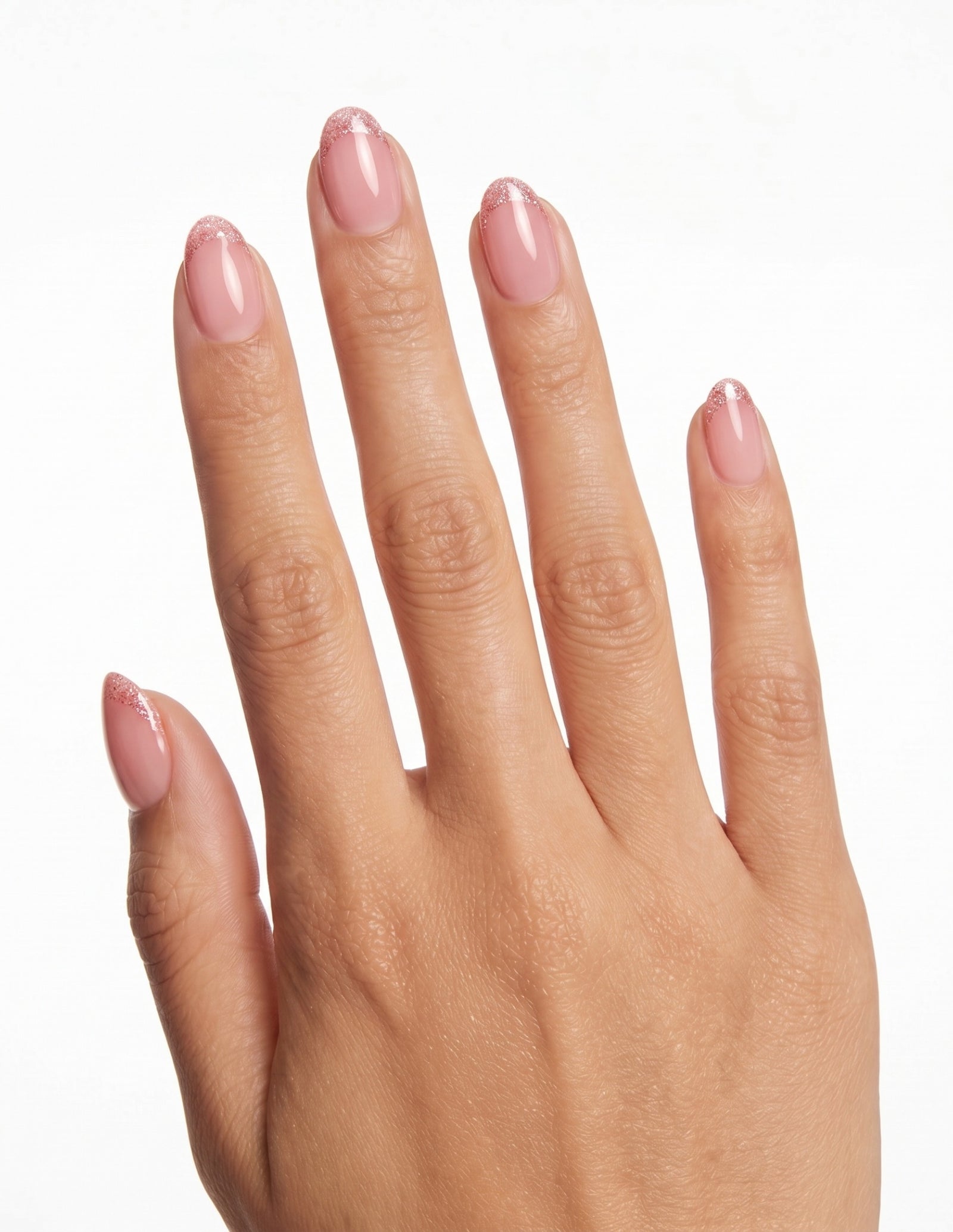 Pearl Tips press-on nails — Almond (extra-short), tan hand, back of hand
