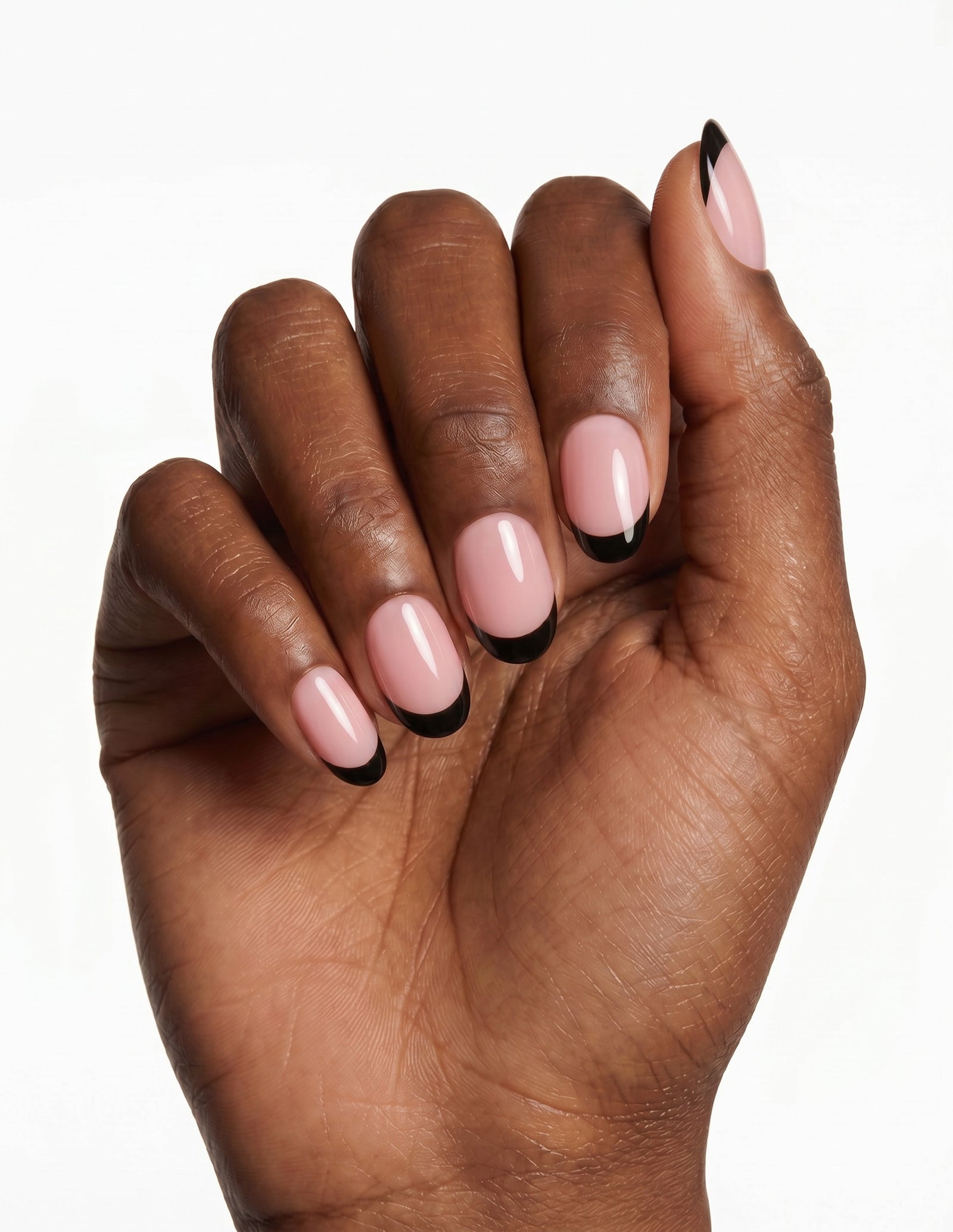 After Hours press-on nails — Almond (extra-short), deep-skin hand, fingers curled