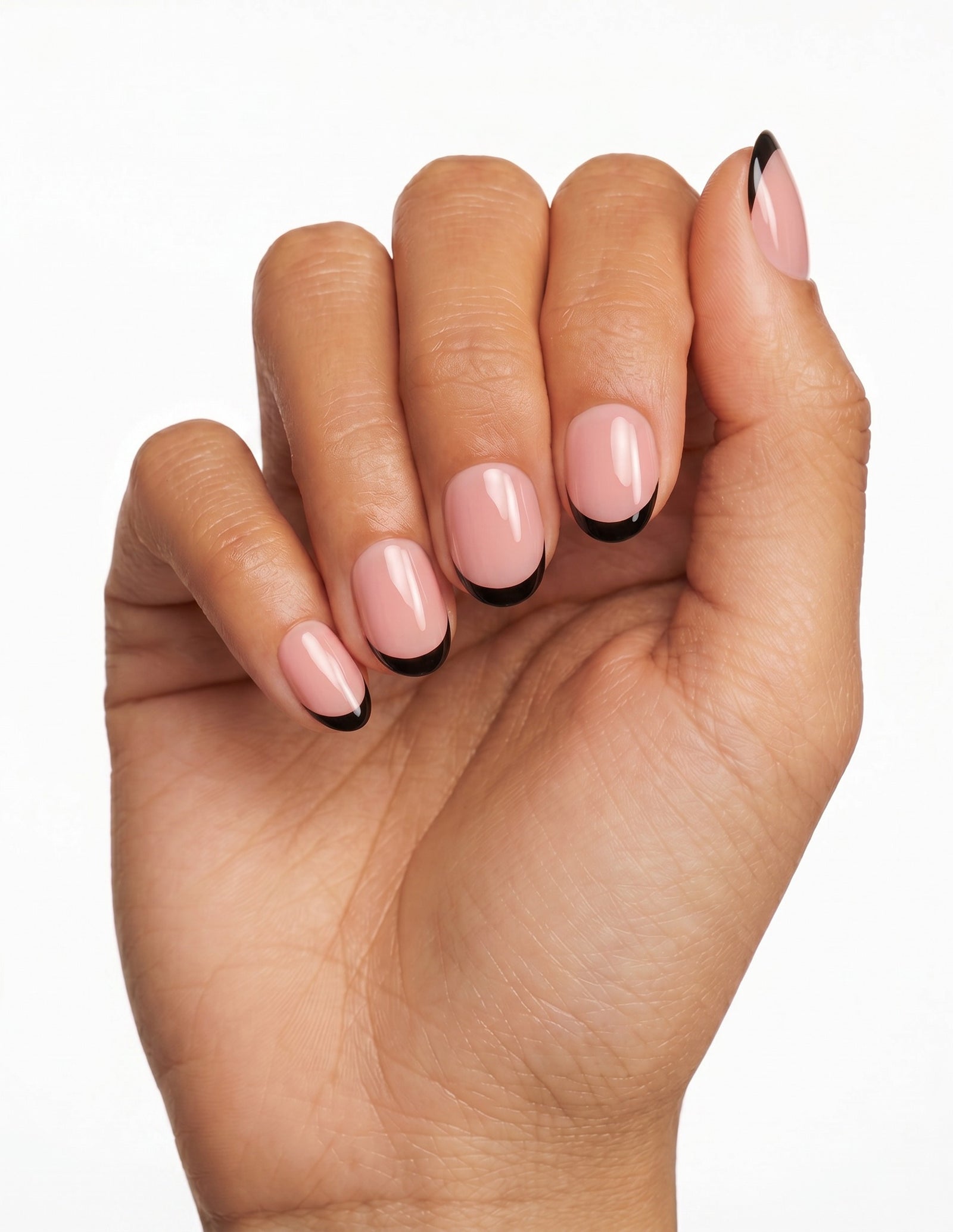 After Hours press-on nails — Oval (extra-short), tan hand, fingers curled