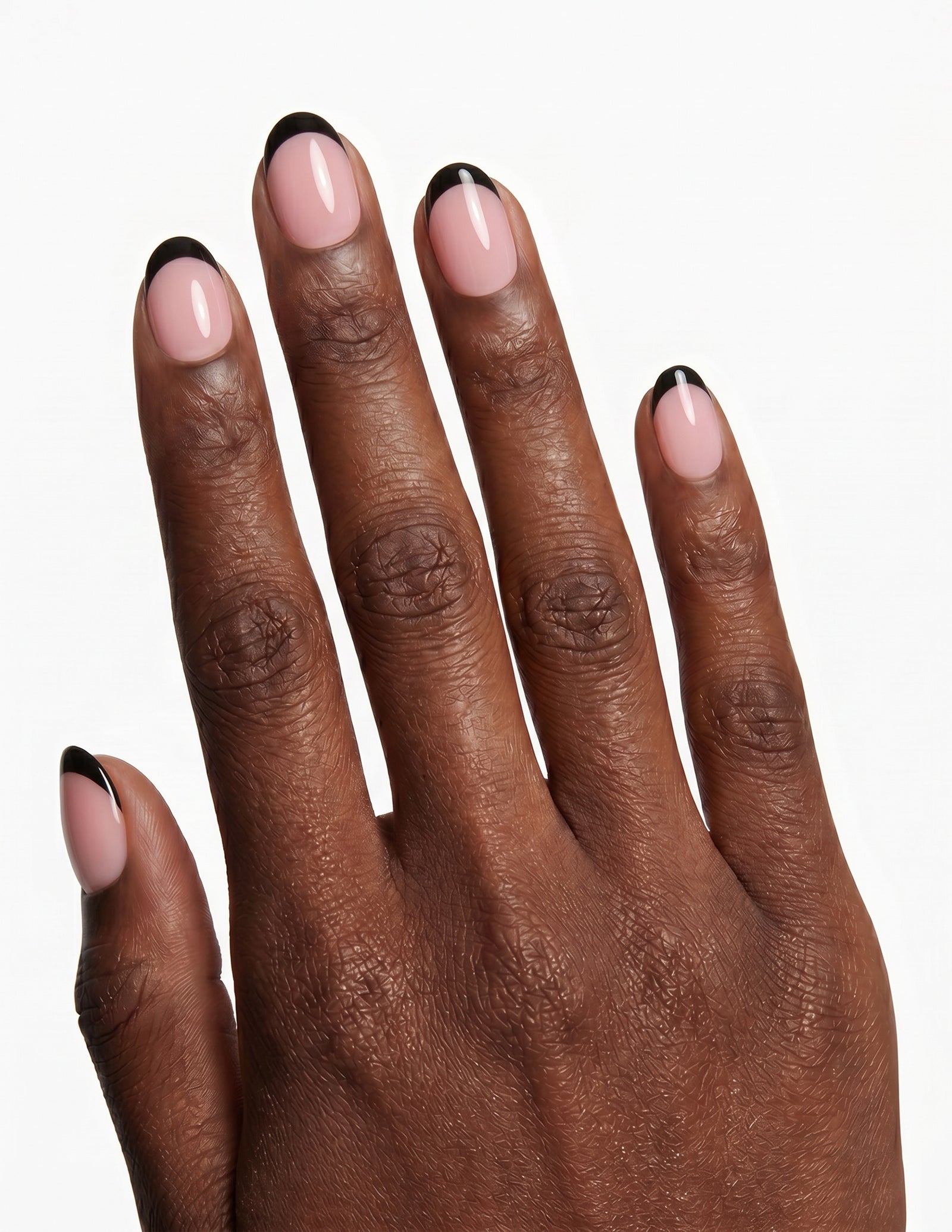 After Hours press-on nails — Oval (extra-short), deep-skin hand, back of hand