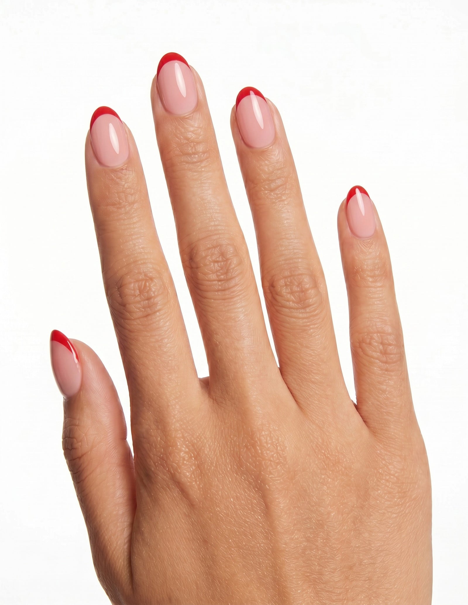 Rouge Tips press-on nails — Almond (extra-short), tan hand, back of hand