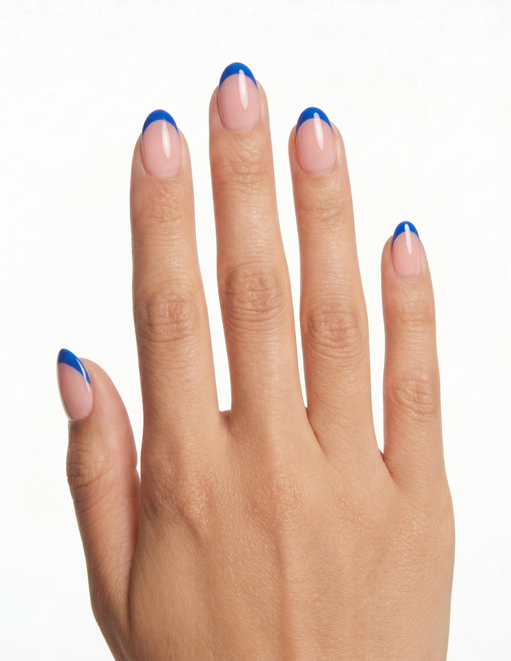 Cobalt Tips press-on nails — Almond (extra-short), tan hand, back of hand
