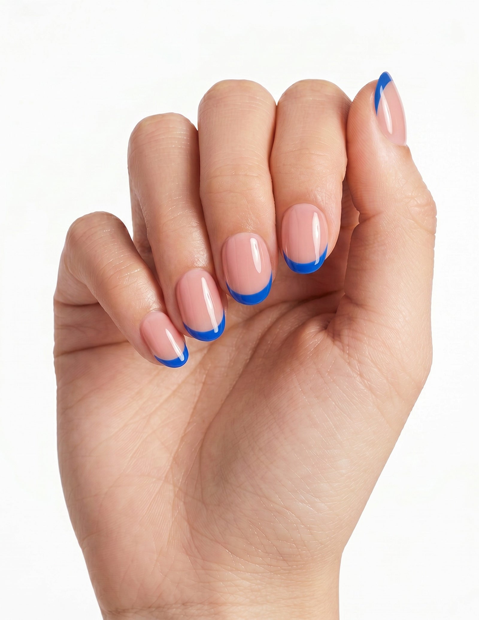 Cobalt Tips press-on nails — Oval (extra-short), light-skin hand, fingers curled
