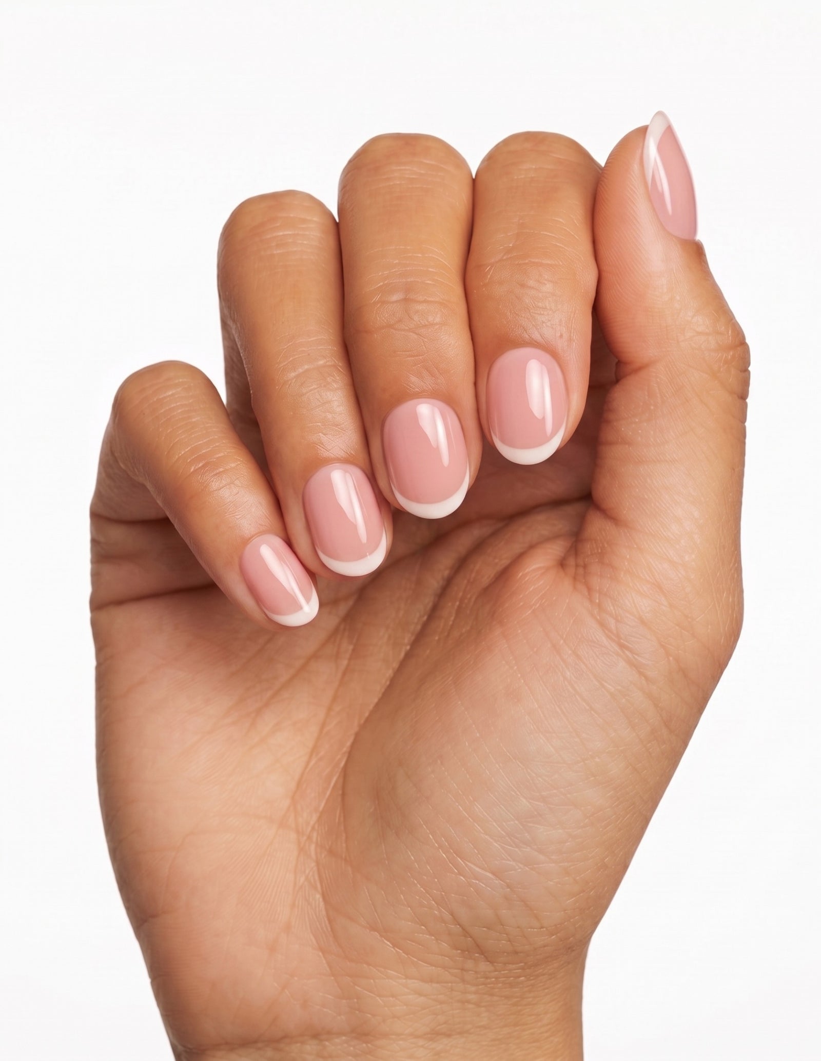 Ballet Tips press-on nails — Oval (extra-short), tan hand, fingers curled