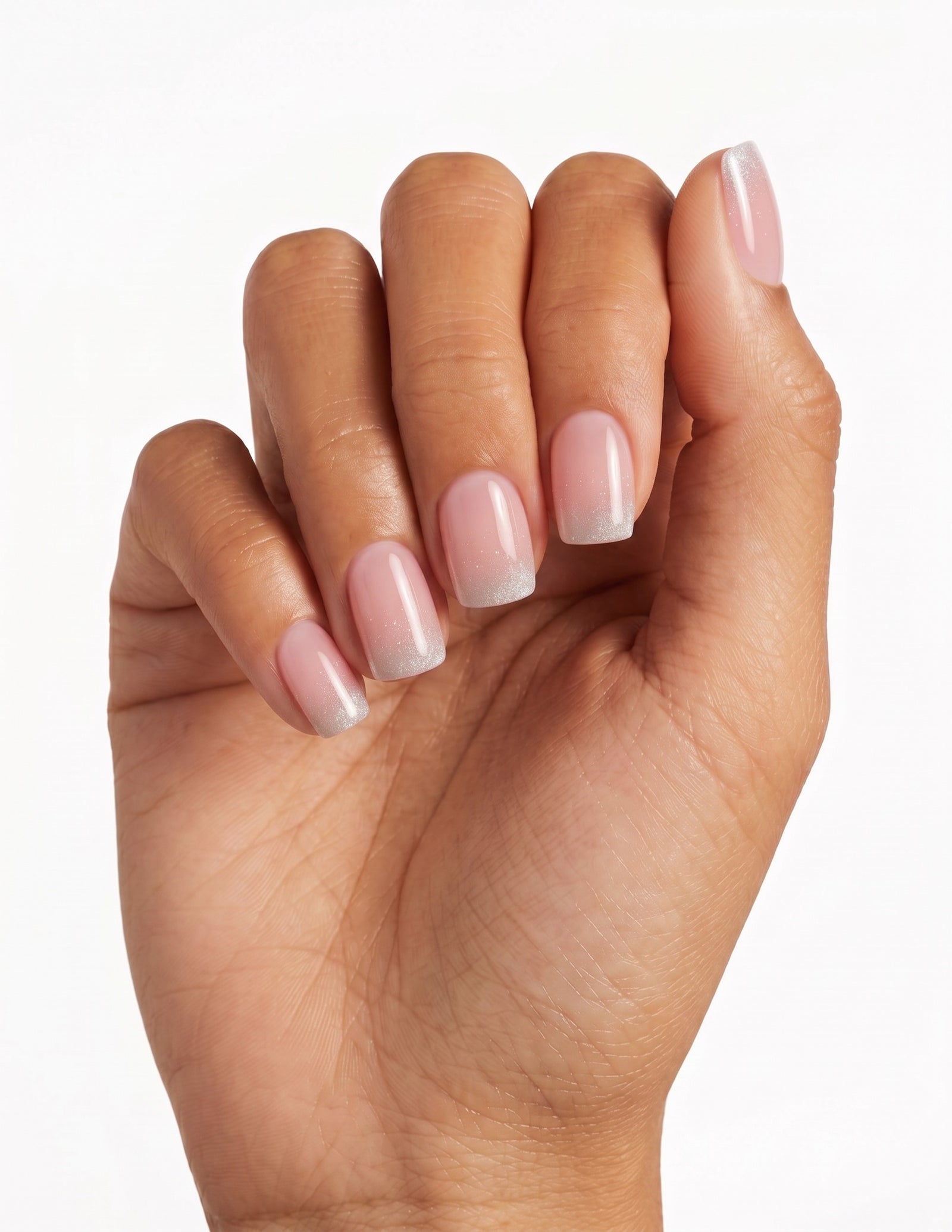 Prosecco press-on nails — Coffin (short), tan hand, fingers curled