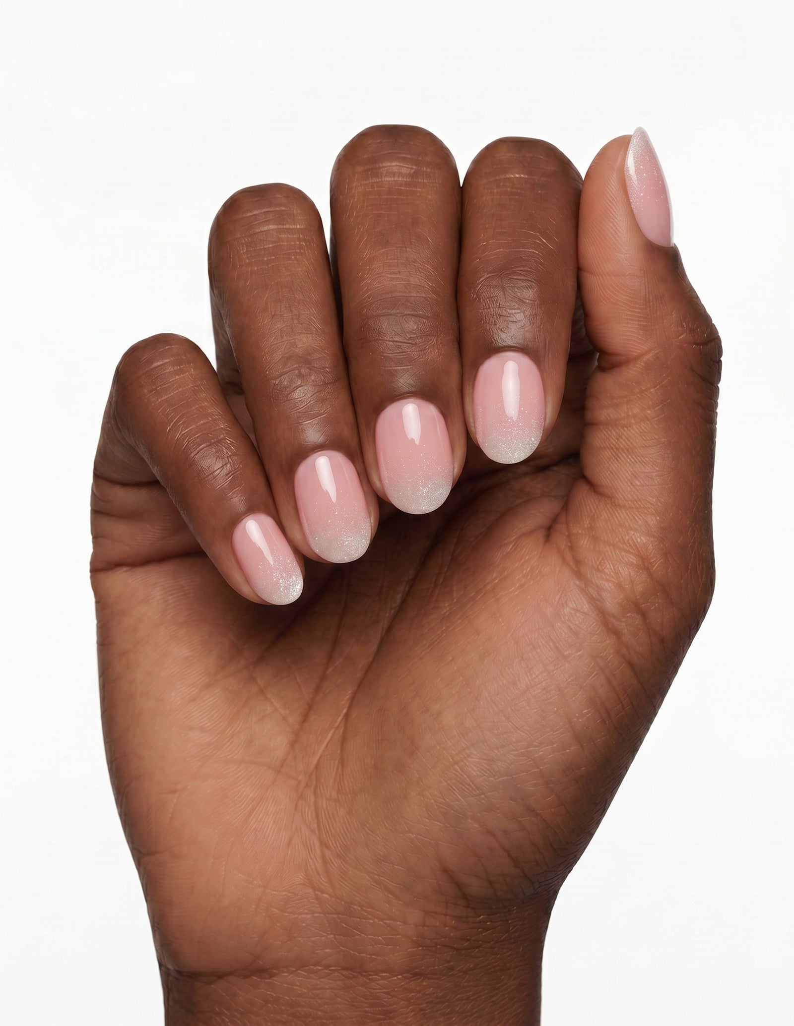 Prosecco press-on nails — Oval (extra-short), deep-skin hand, fingers curled