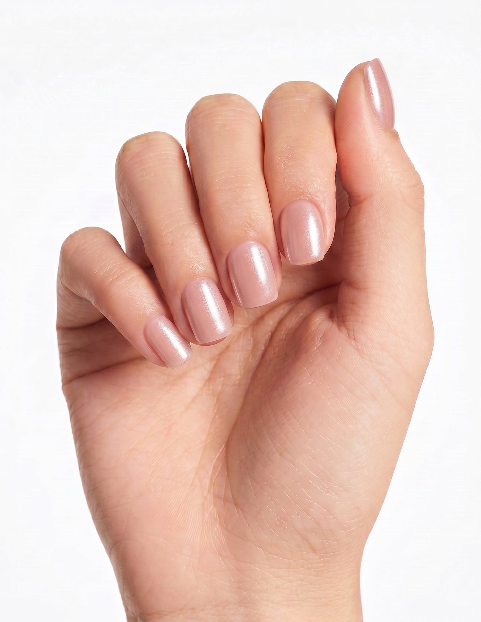 Bare Minimum press-on nails — Coffin (short), tan hand, fingers curled