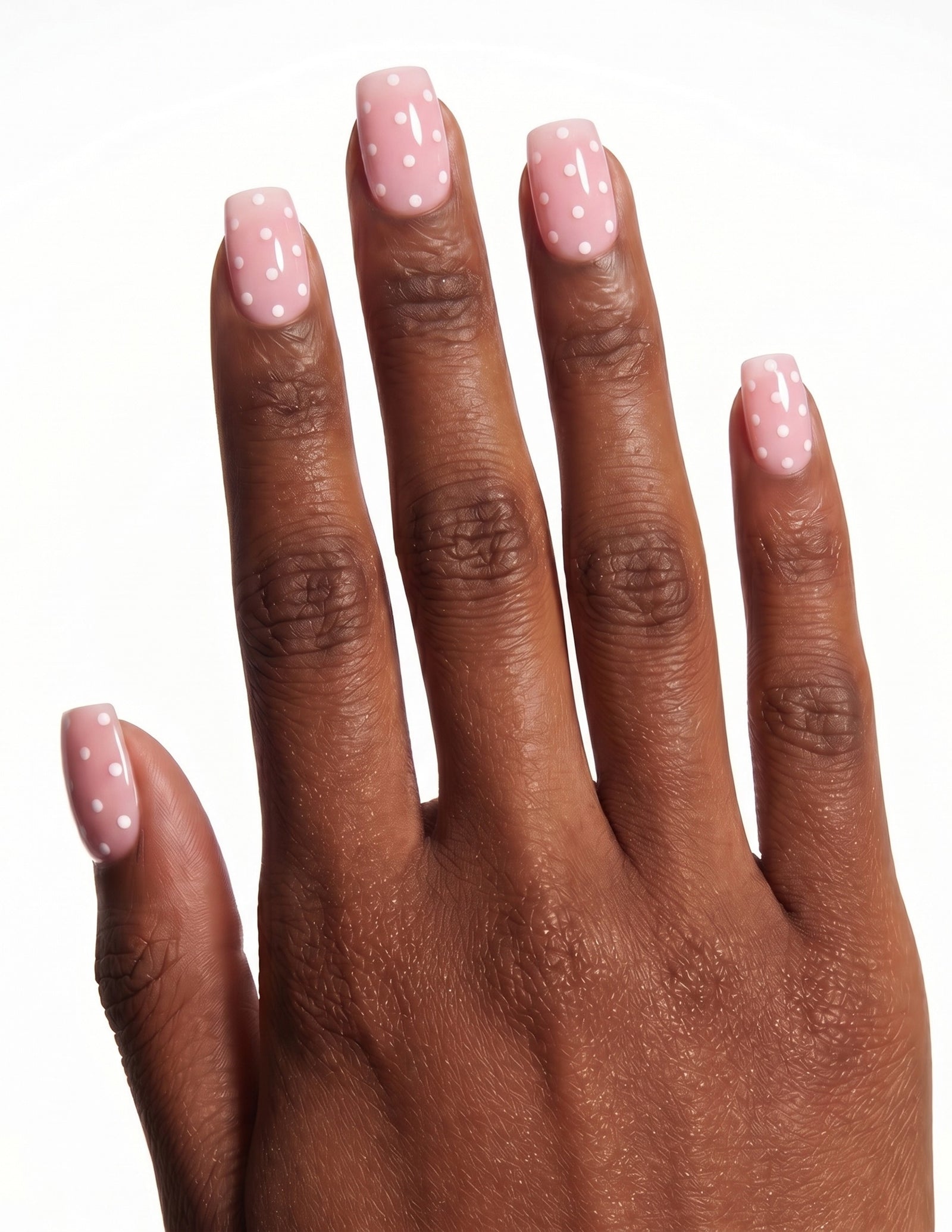 Polka Pink press-on nails — Coffin (short), deep-skin hand, back of hand