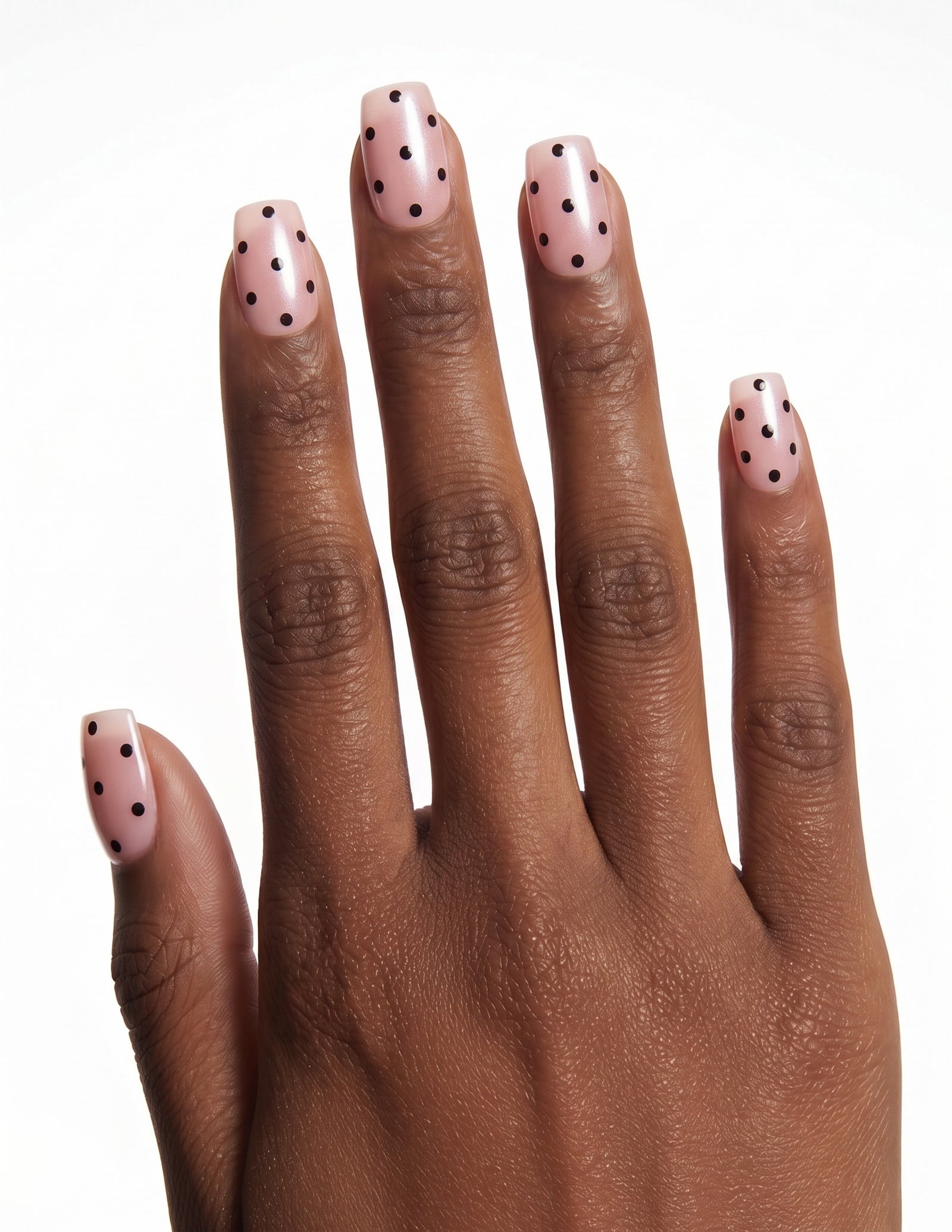 Dalmatian Duchess press-on nails — Coffin (short), deep-skin hand, back of hand