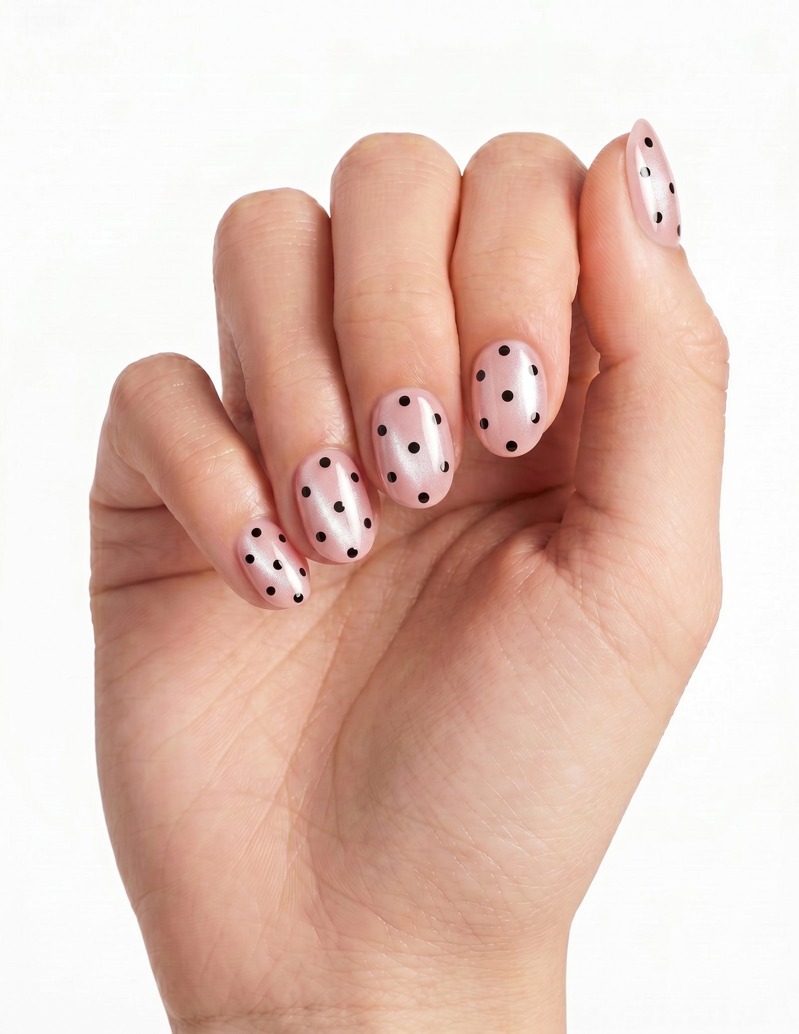Dalmatian Duchess press-on nails — Oval (extra-short), deep-skin hand, fingers curled