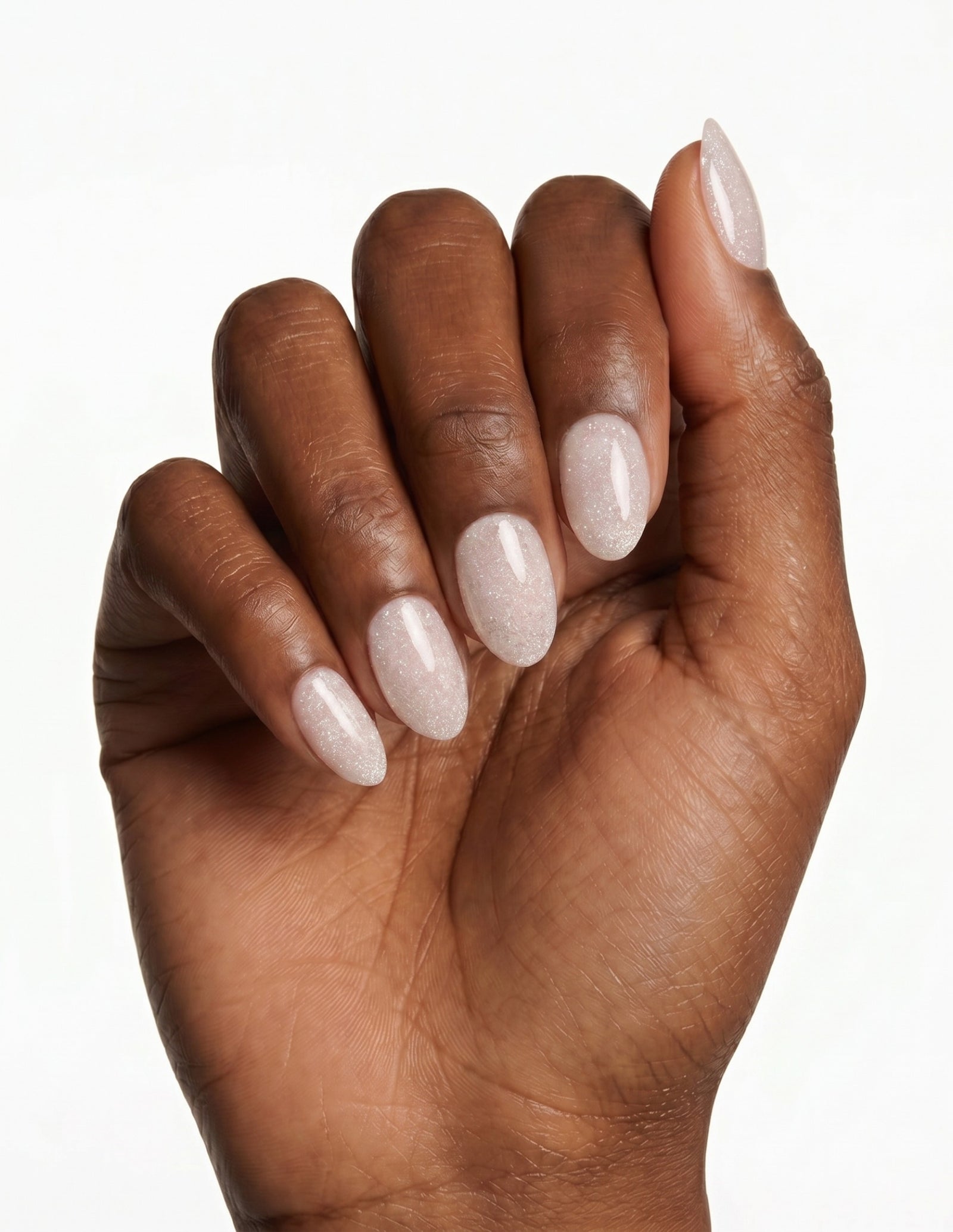 Disco Velvet press-on nails — Almond (extra-short), deep-skin hand, fingers curled