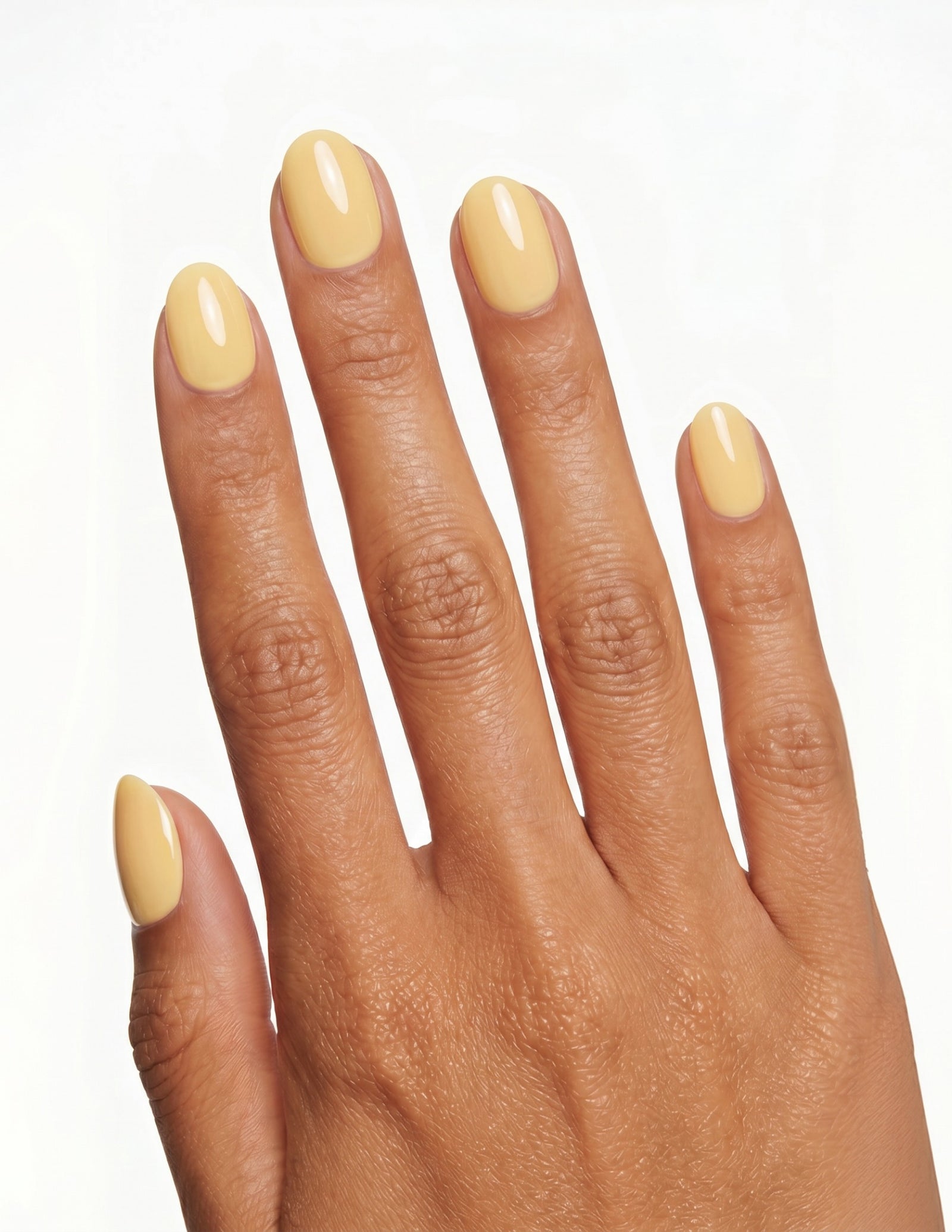 Butter press-on nails — Oval (extra-short), tan hand, back of hand