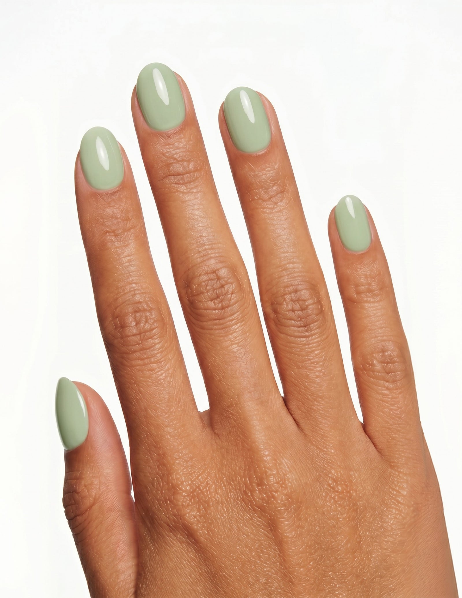 Pistachio press-on nails — Oval (extra-short), deep-skin hand, back of hand