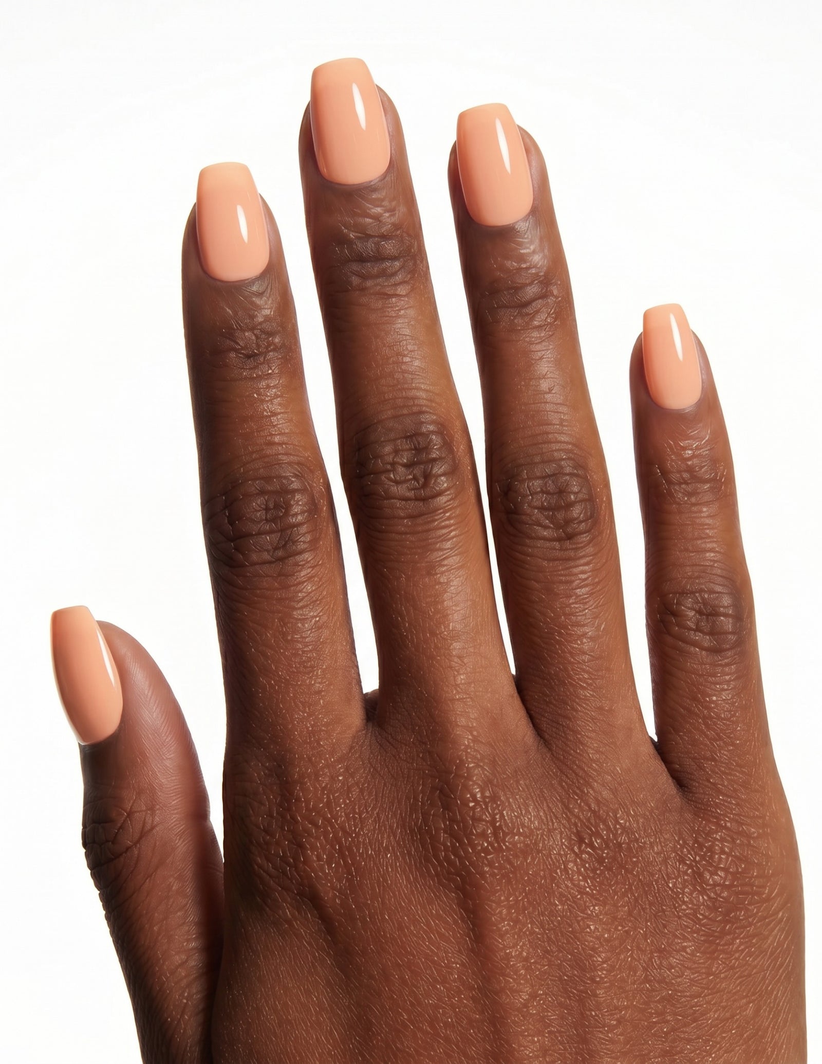 Apricot press-on nails — Coffin (short), deep-skin hand, back of hand