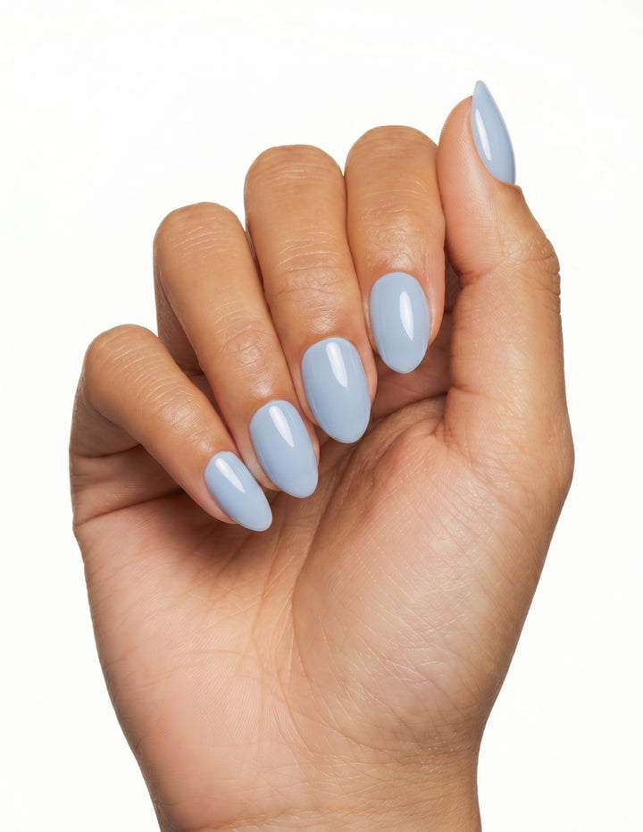 Baby Blue press-on nails — Almond (extra-short), tan hand, fingers curled