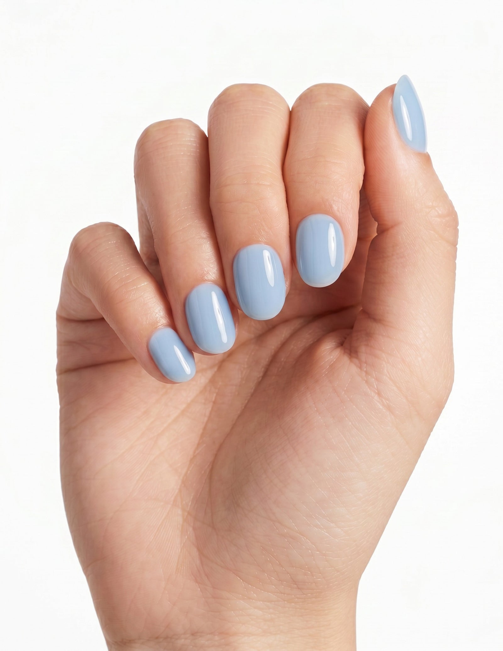 Baby Blue press-on nails — Oval (extra-short), light-skin hand, fingers curled