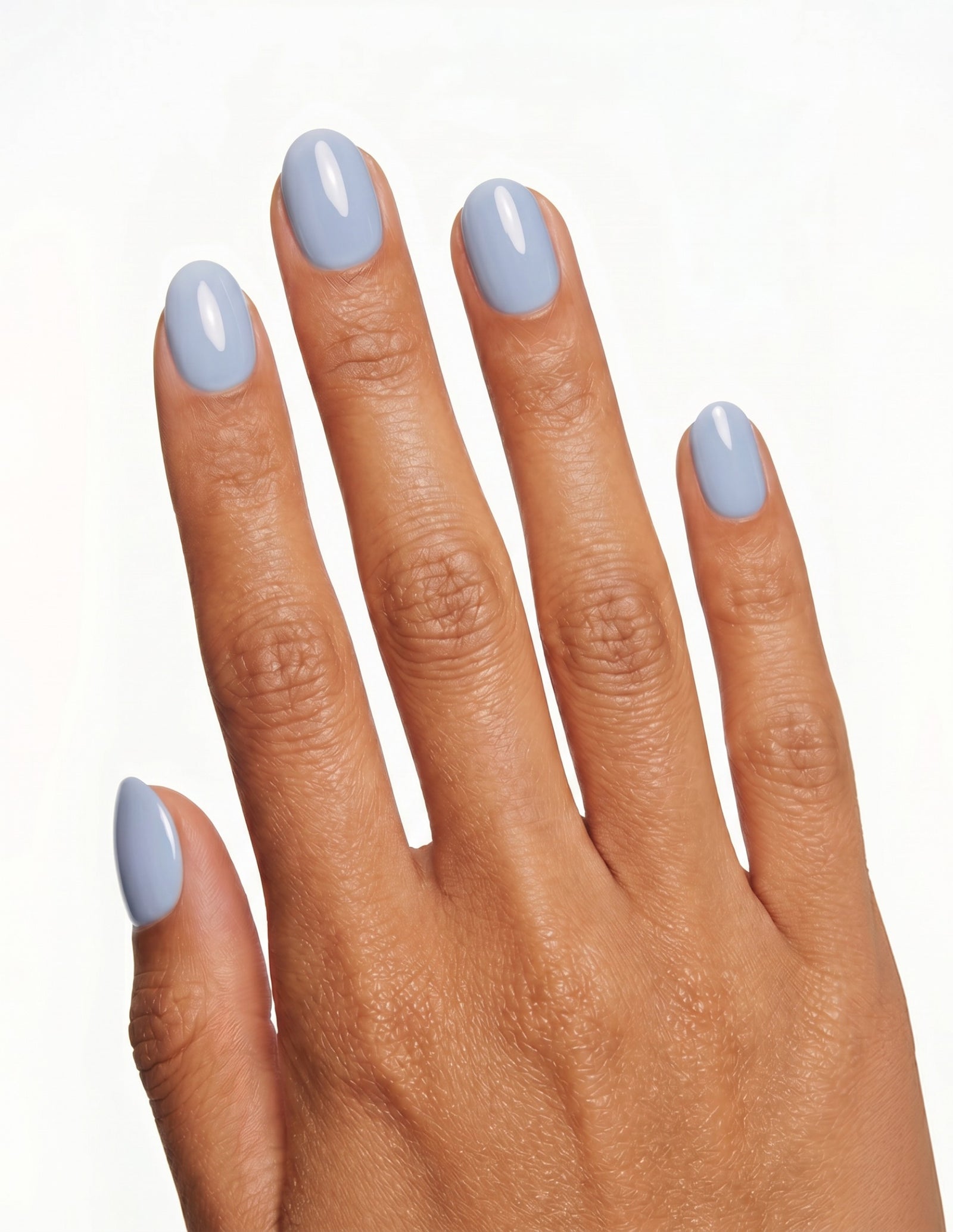 Baby Blue press-on nails — Oval (extra-short), tan hand, back of hand
