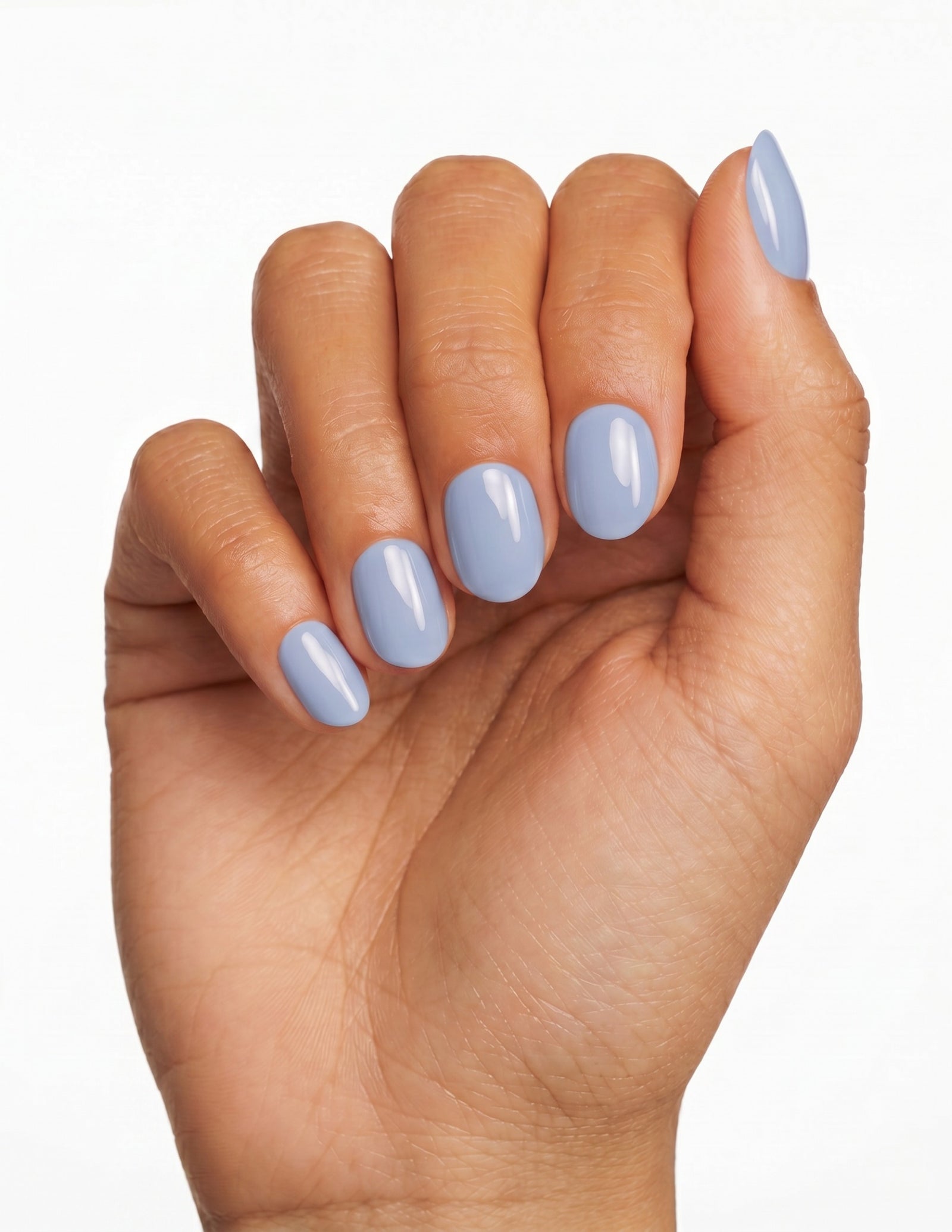 Baby Blue press-on nails — Oval (extra-short), deep-skin hand, fingers curled
