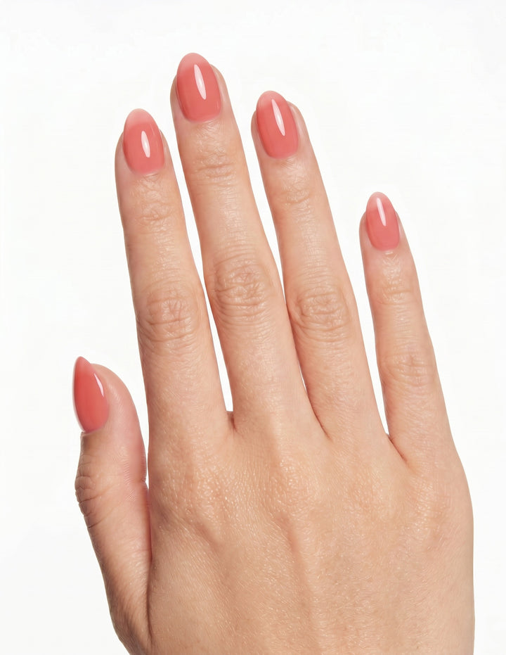 Guava press-on nails — Almond (extra-short), light-skin hand, back of hand