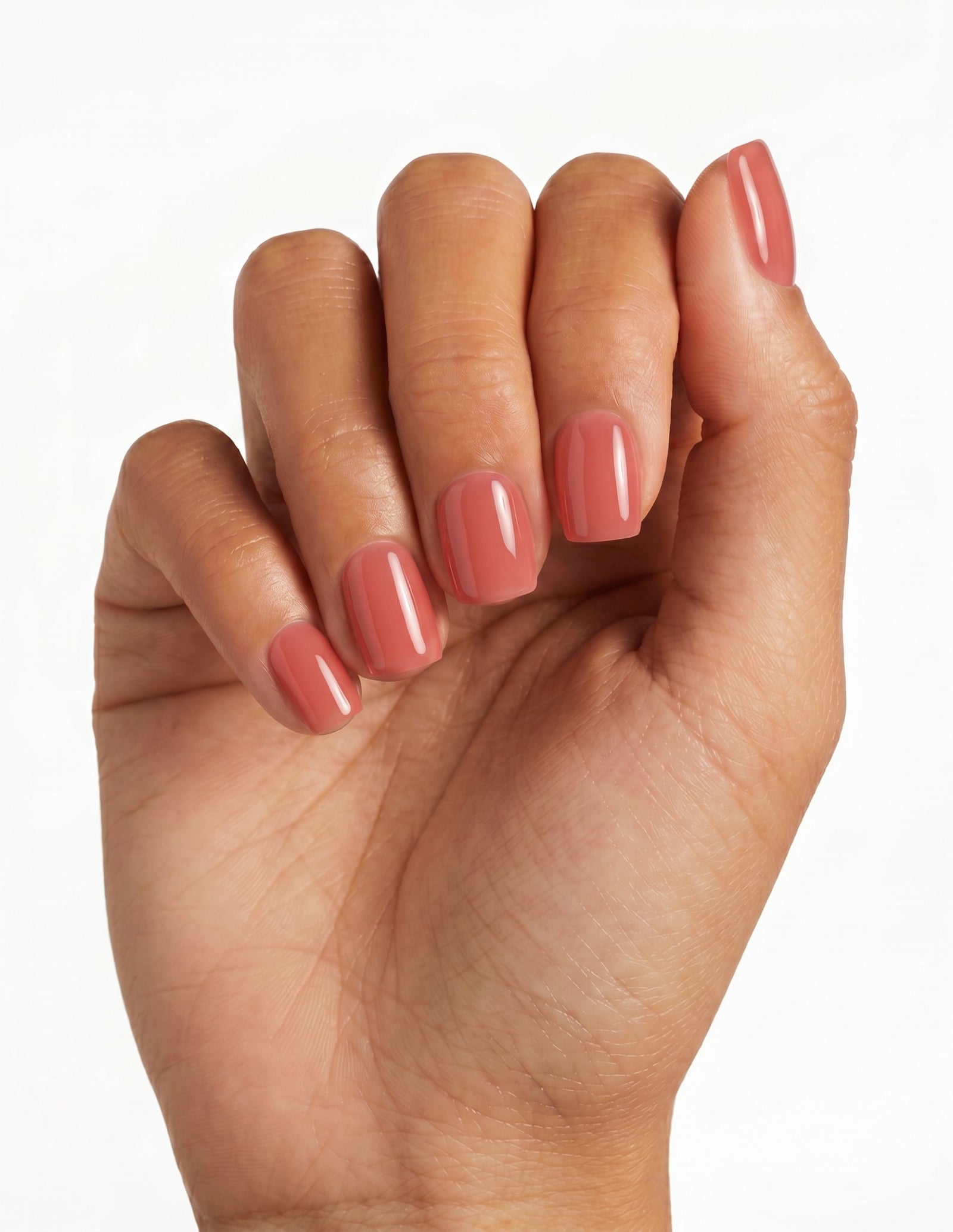 Guava press-on nails — Coffin (short), tan hand, fingers curled