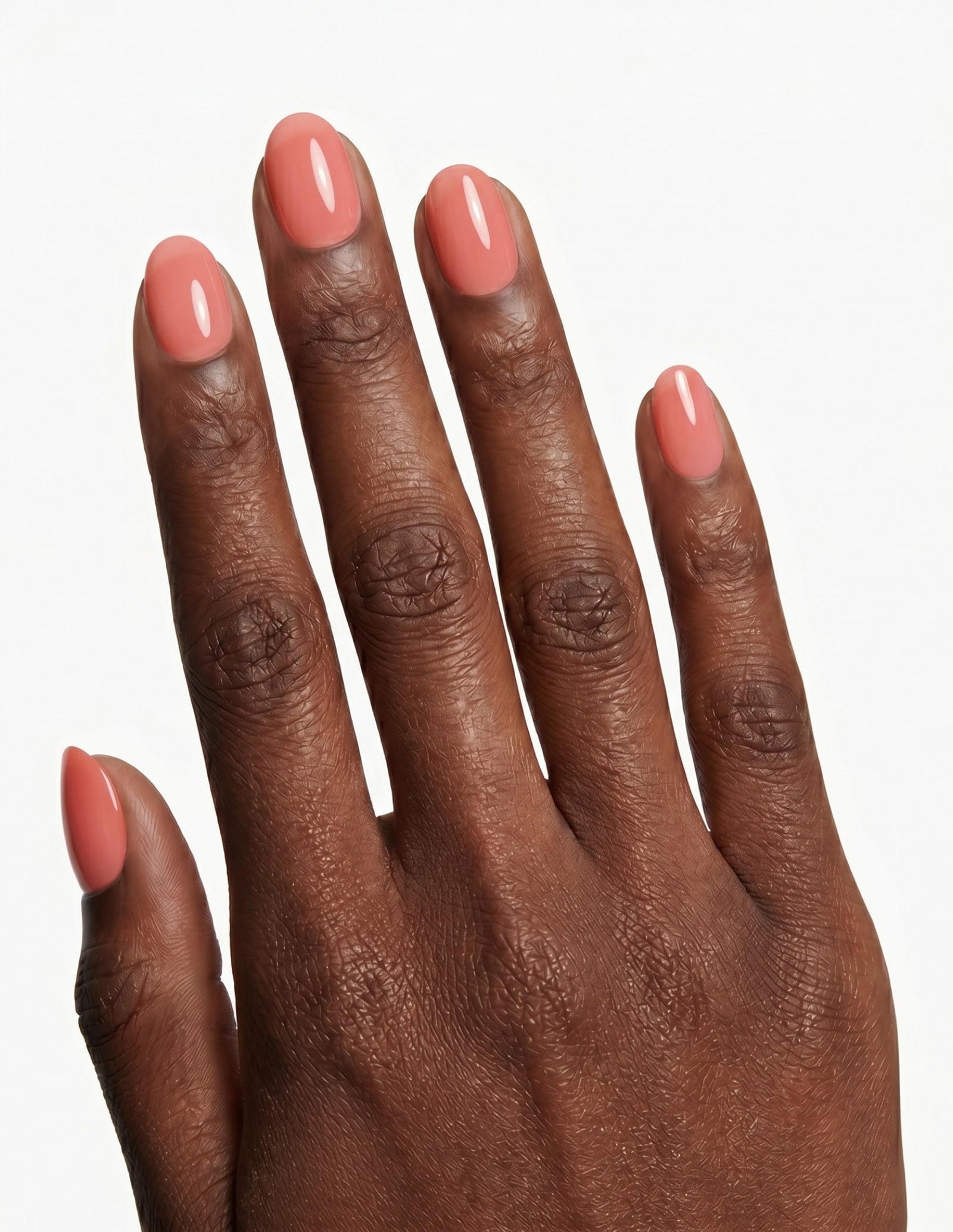 Guava press-on nails — Oval (extra-short), deep-skin hand, back of hand