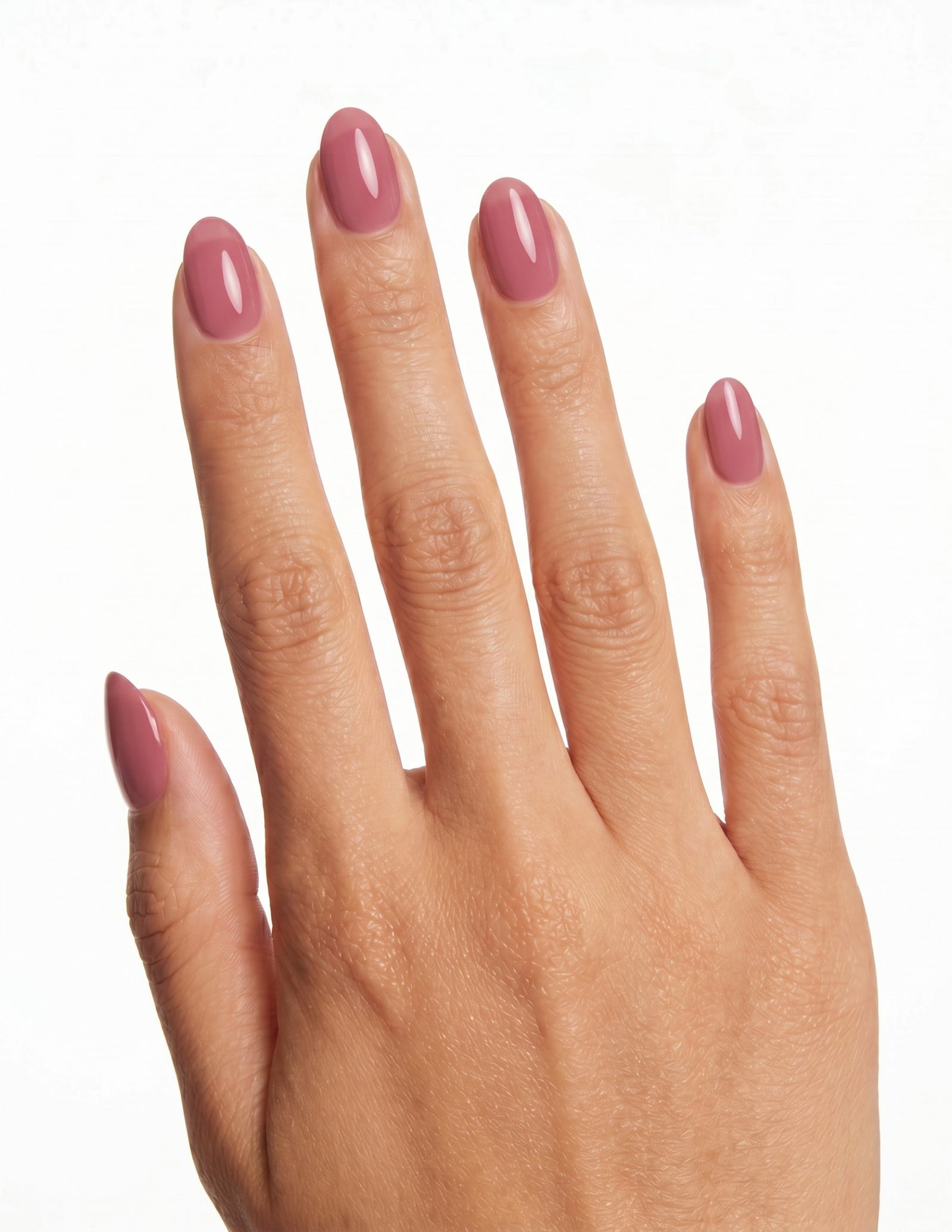 Rose Milk press-on nails — Almond (extra-short), tan hand, back of hand