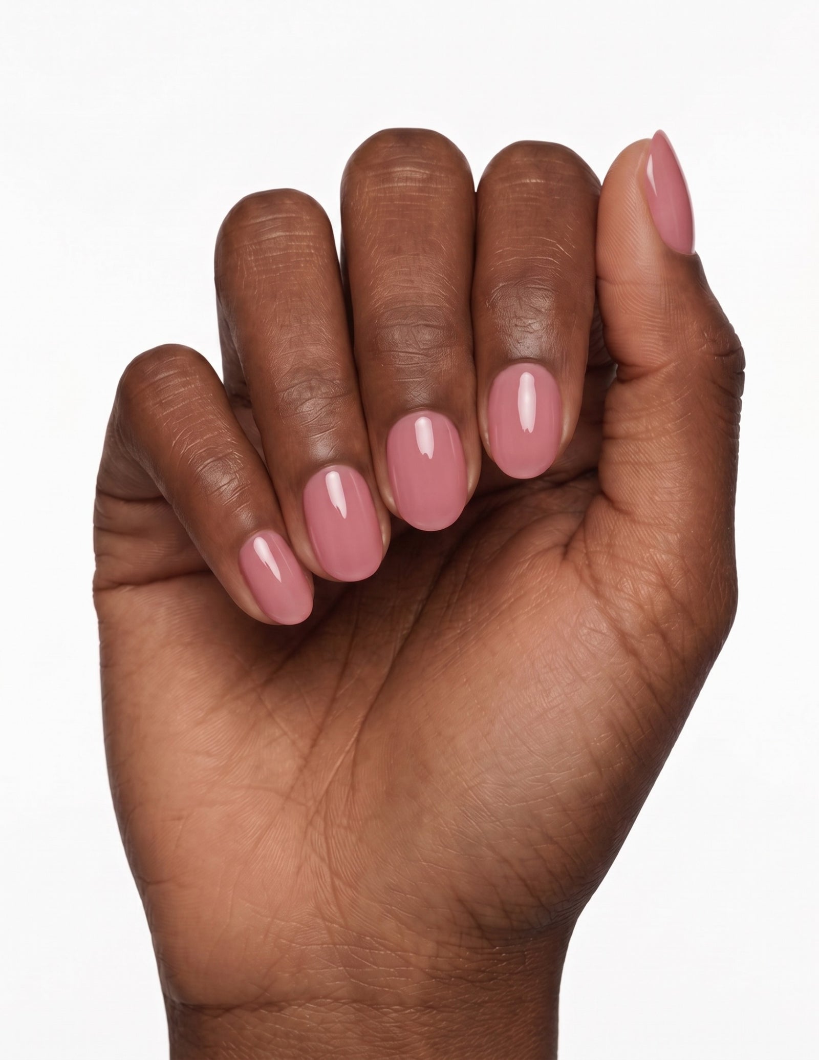 Rose Milk press-on nails — Oval (extra-short), deep-skin hand, fingers curled