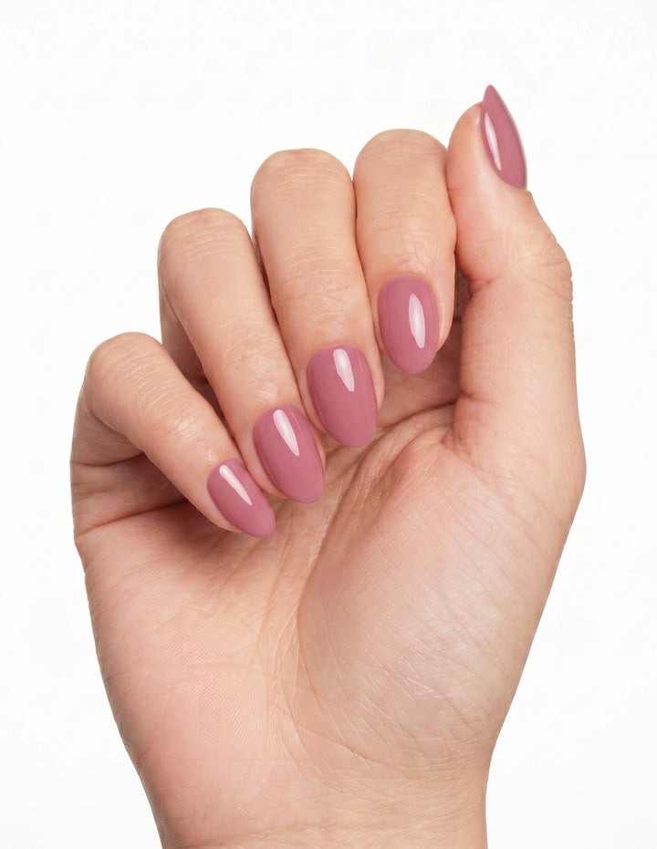 Bubblegum press-on nails — Almond (extra-short), tan hand, fingers curled