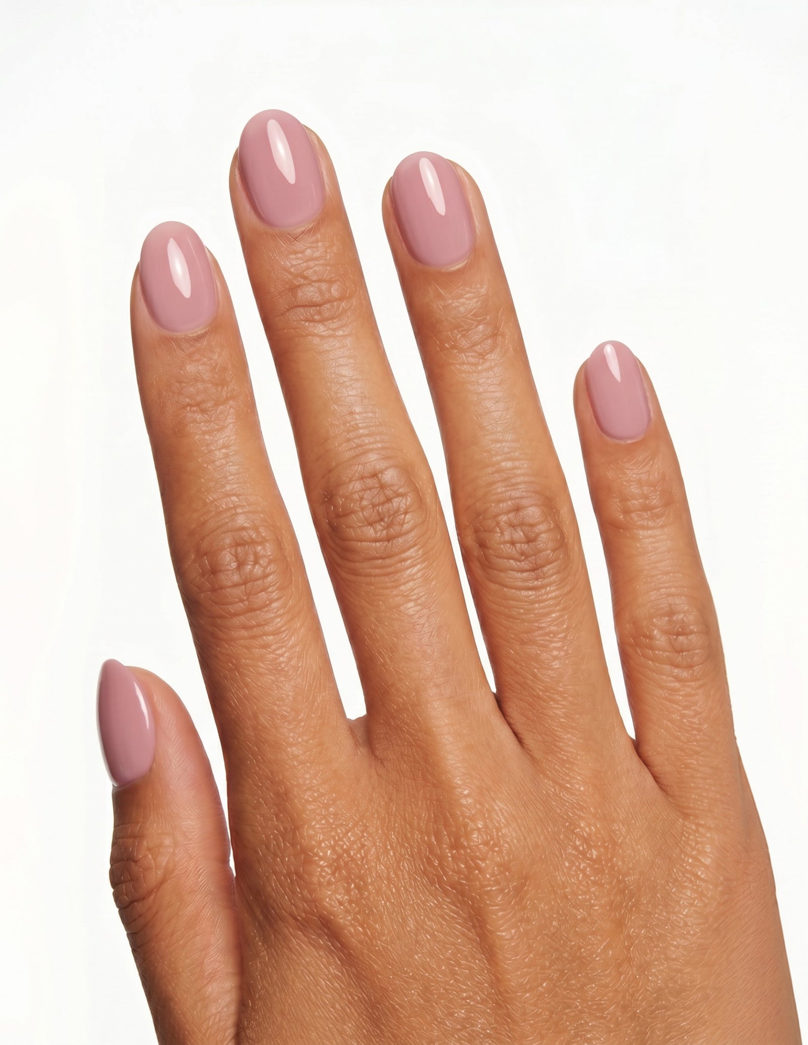 Bubblegum press-on nails — Oval (extra-short), tan hand, back of hand