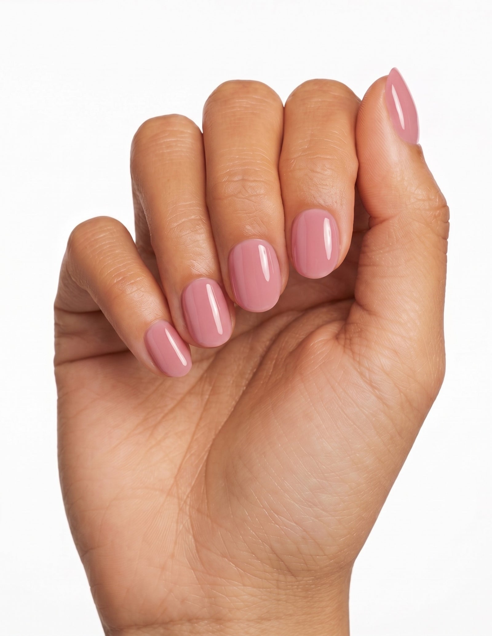 Dusty Rose press-on nails — Oval (extra-short), tan hand, fingers curled