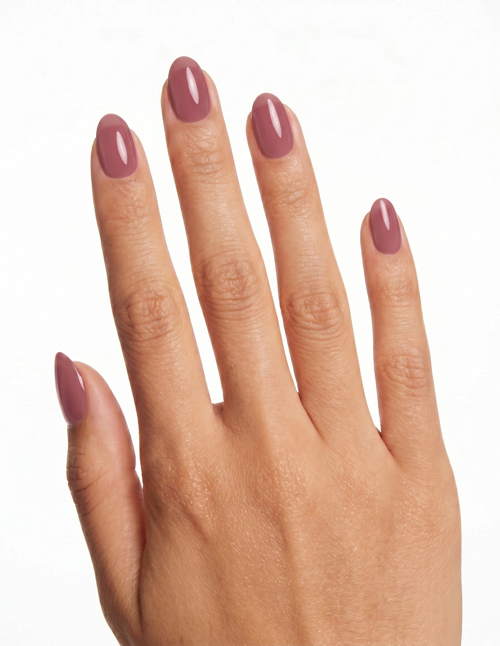 Mauve press-on nails — Almond (extra-short), tan hand, back of hand