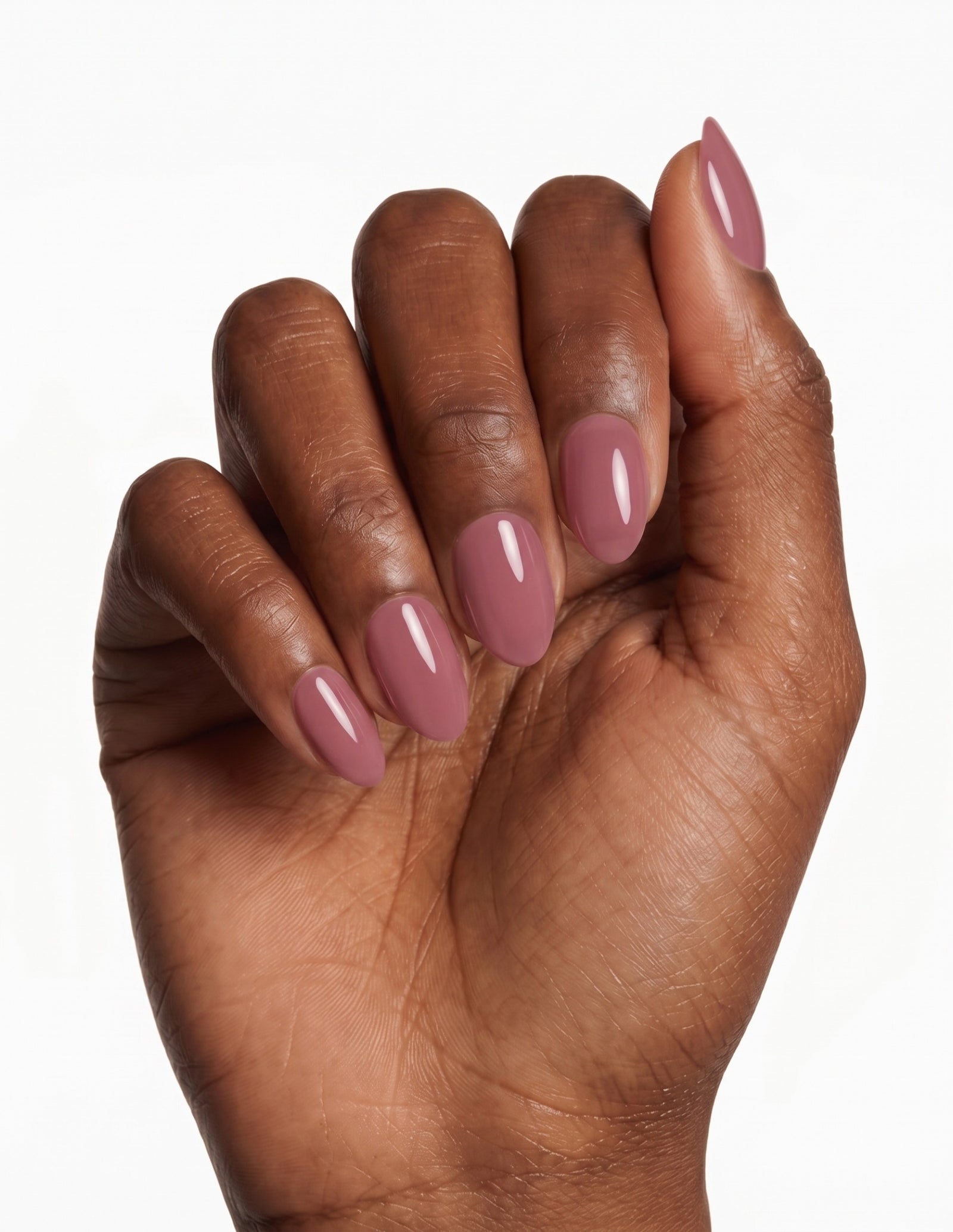 Mauve press-on nails — Almond (extra-short), deep-skin hand, fingers curled
