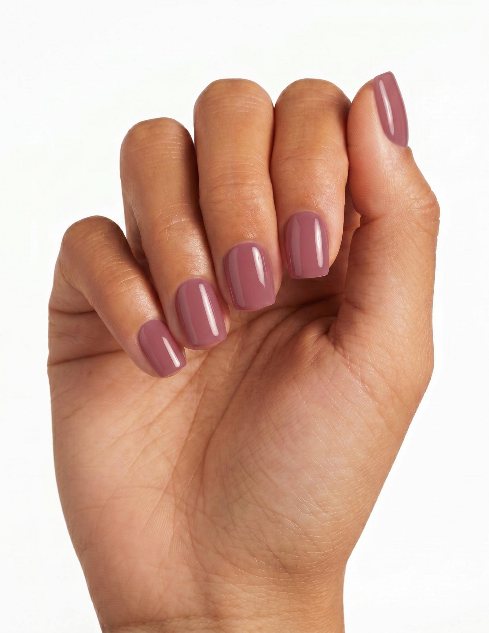 Mauve press-on nails — Coffin (short), tan hand, fingers curled