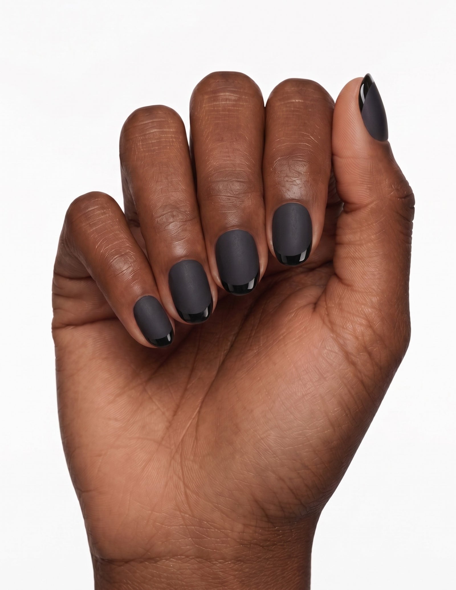 Ink press-on nails — Oval (extra-short), deep-skin hand, fingers curled