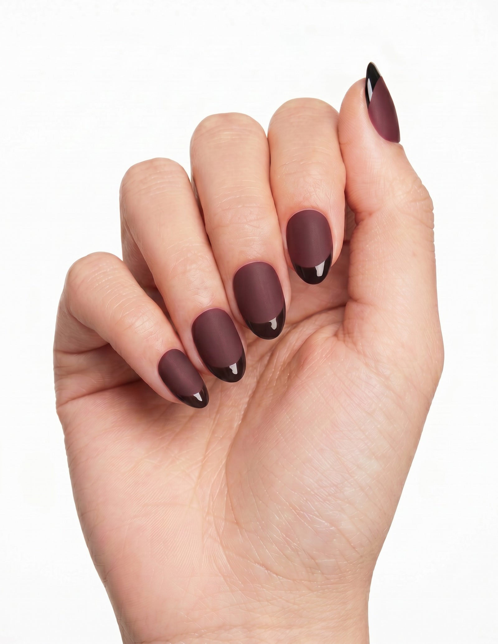Bordeaux press-on nails — Almond (extra-short), tan hand, fingers curled