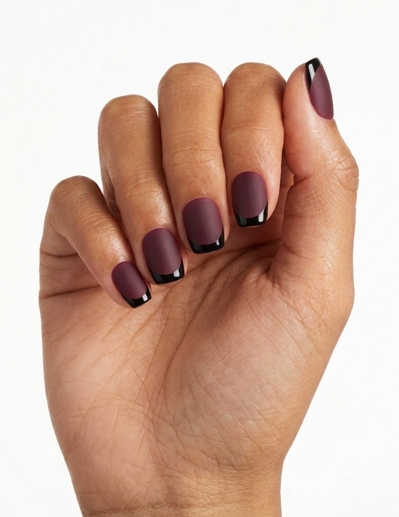 Bordeaux press-on nails — Coffin (short), tan hand, fingers curled